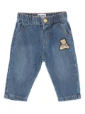 Moschino Kids teddy-patch denim trousers - Blue