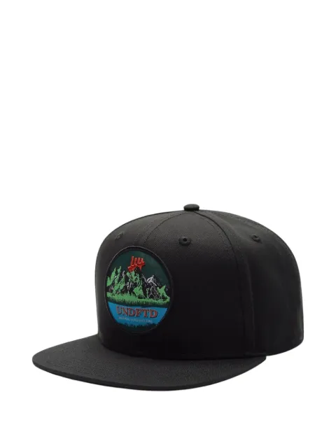 Undefeated mountain-scene patch snapback cap