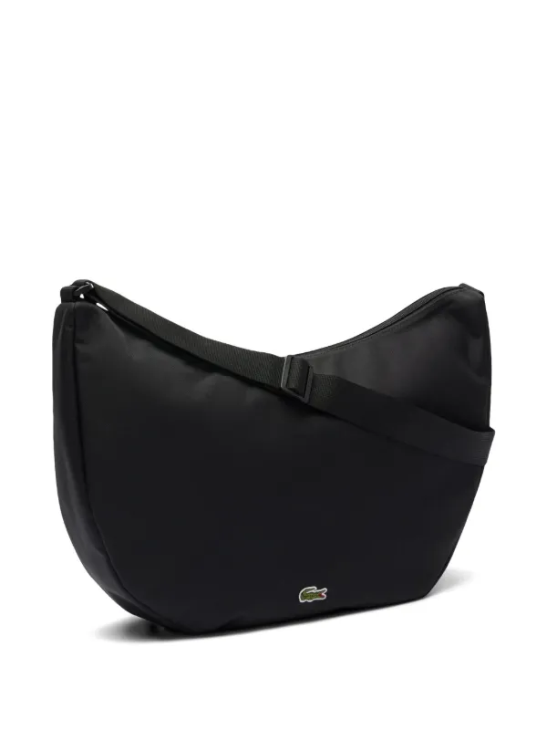 Lacoste crescent-shaped zip-top Cross Body Bag | Black | FARFETCH