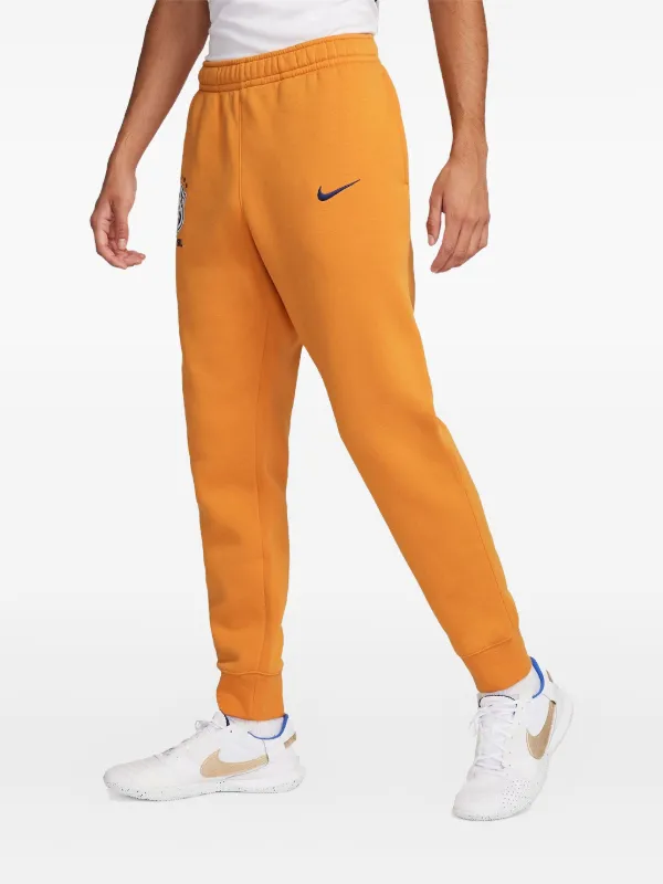 orange nike track pants