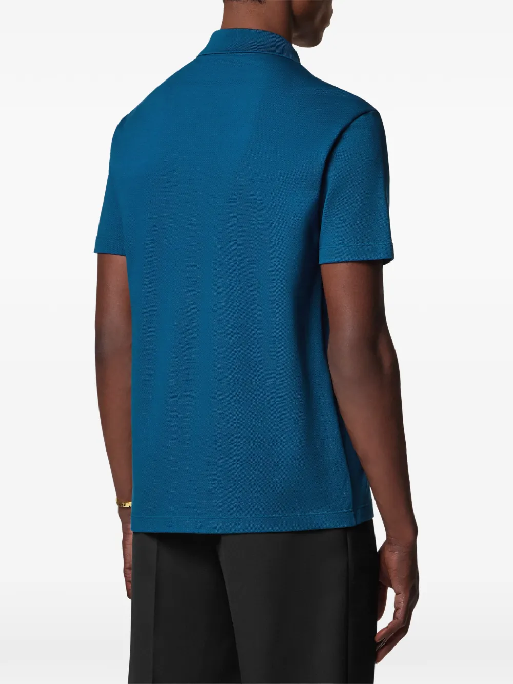 Versace Katoenen piqué poloshirt met borduurwerk en halve rits Blauw
