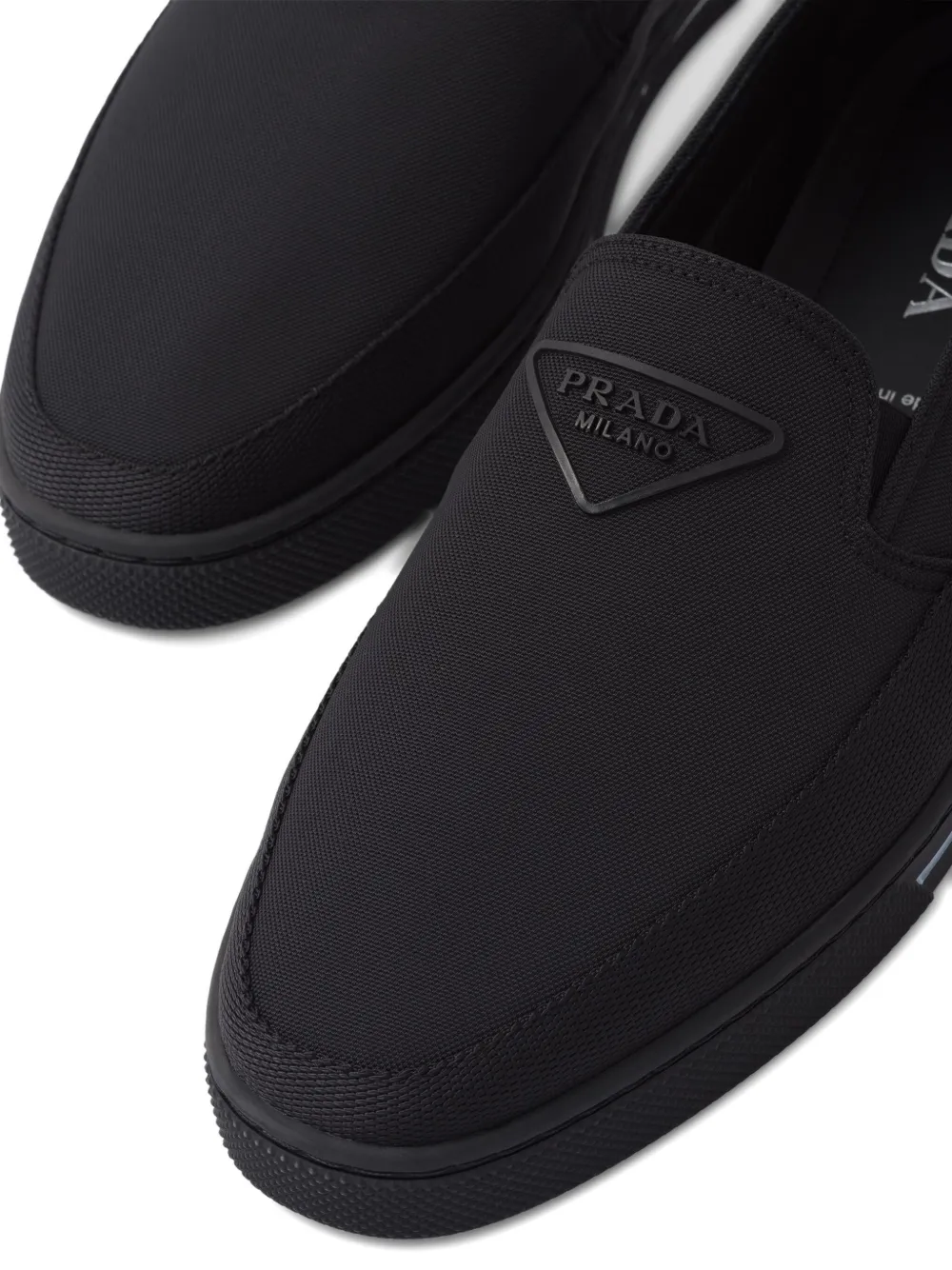 Prada Re-nylon Embossed Logo Slip-on Trainers In Black