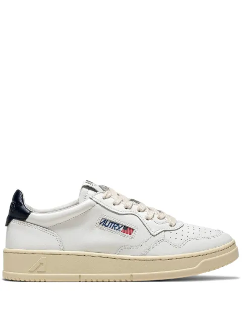 Autry navy trim medalist low trainers