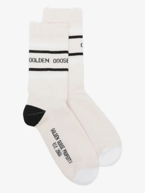 Golden Goose blush-colored socks with distressed details and black and white stripes