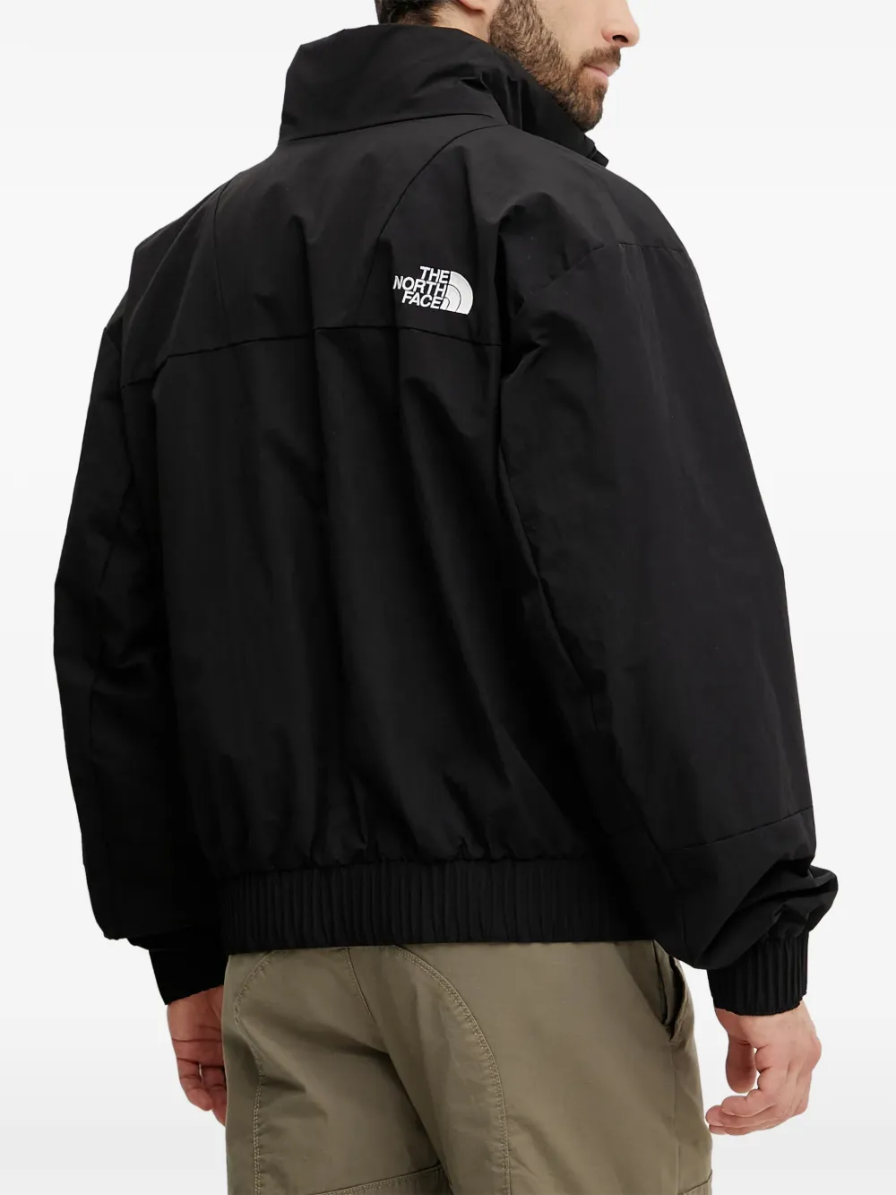 The North Face NSE bomberjack met logo Zwart
