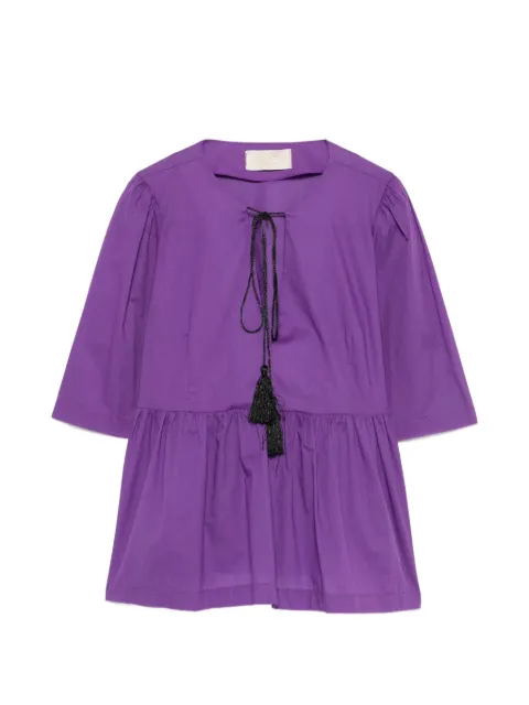 kaos blusa con peplum y borlas