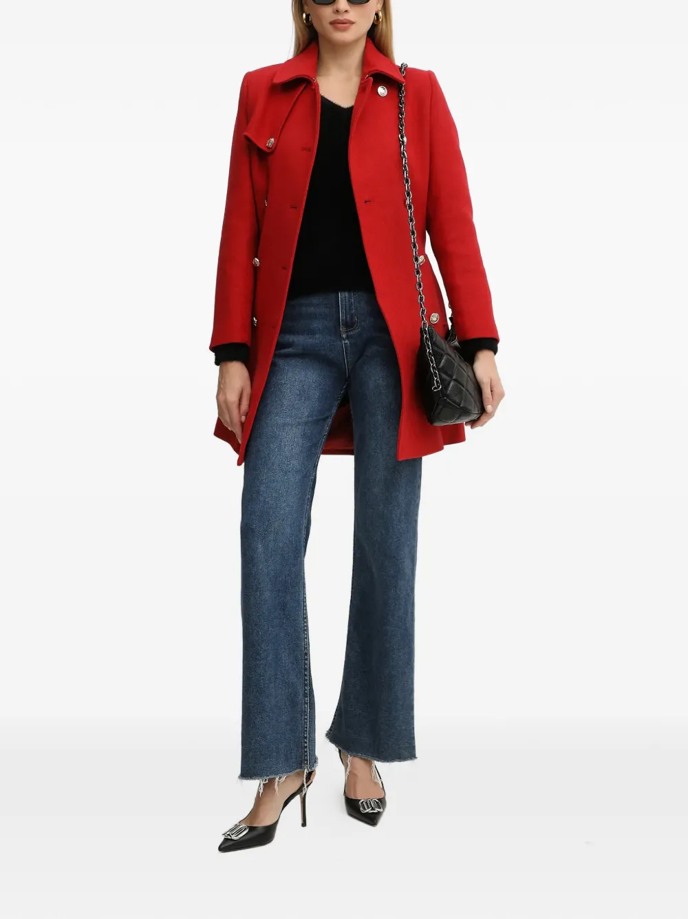 Woman in black jeans and red statement coat