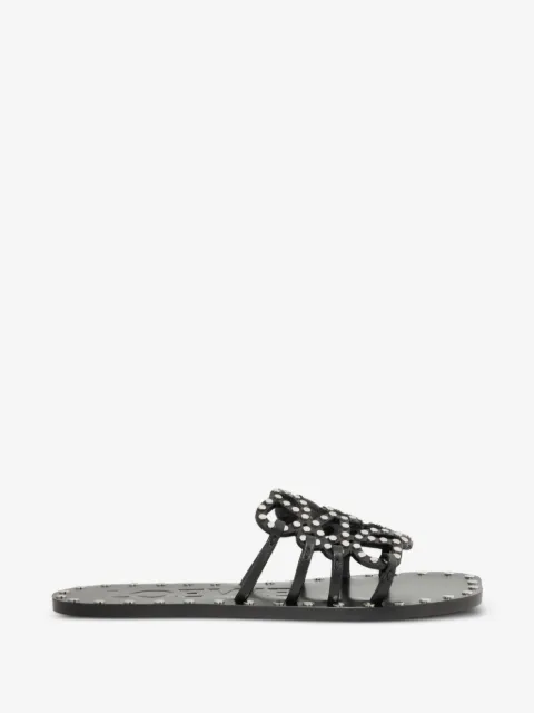 petal Anagram slides in vegetable-tanned calfskin and metallic studs