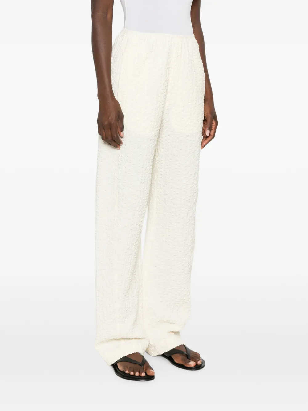Nanushka Broek met wijde pijpen en seersucker-effect Beige