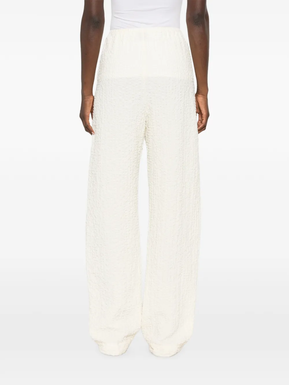 Nanushka Broek met wijde pijpen en seersucker-effect Beige
