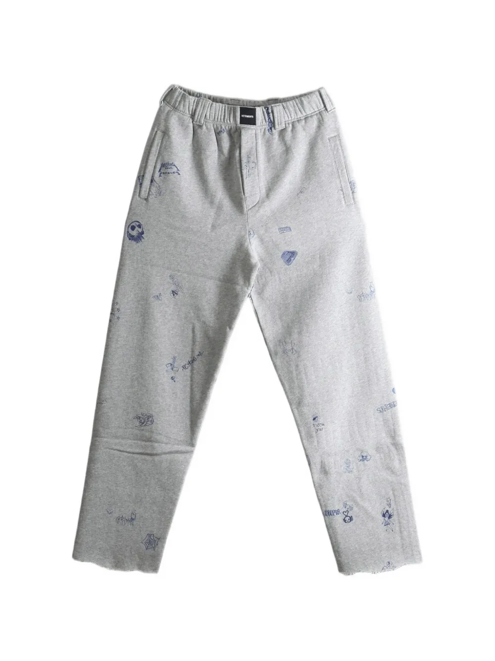 VETEMENTS scribble-print raw-edge track pants - Grau