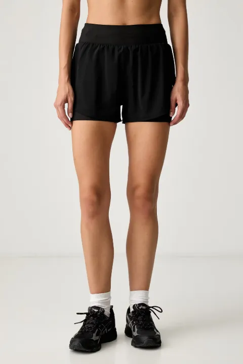 PUMA Dreamrun dryCELL layered logo-print shorts