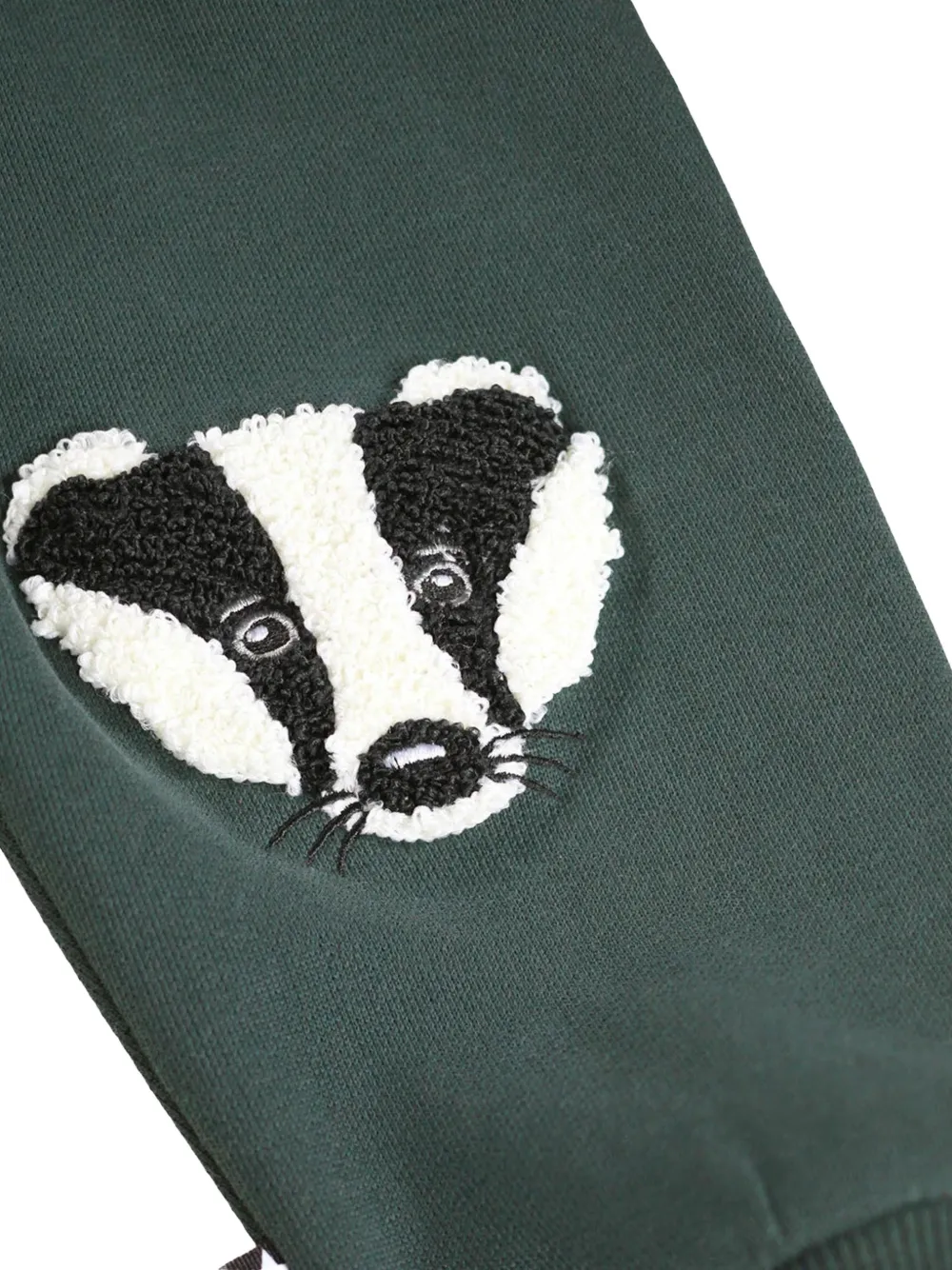 Molo Simeon trainingsbroek met dassen-patch Groen