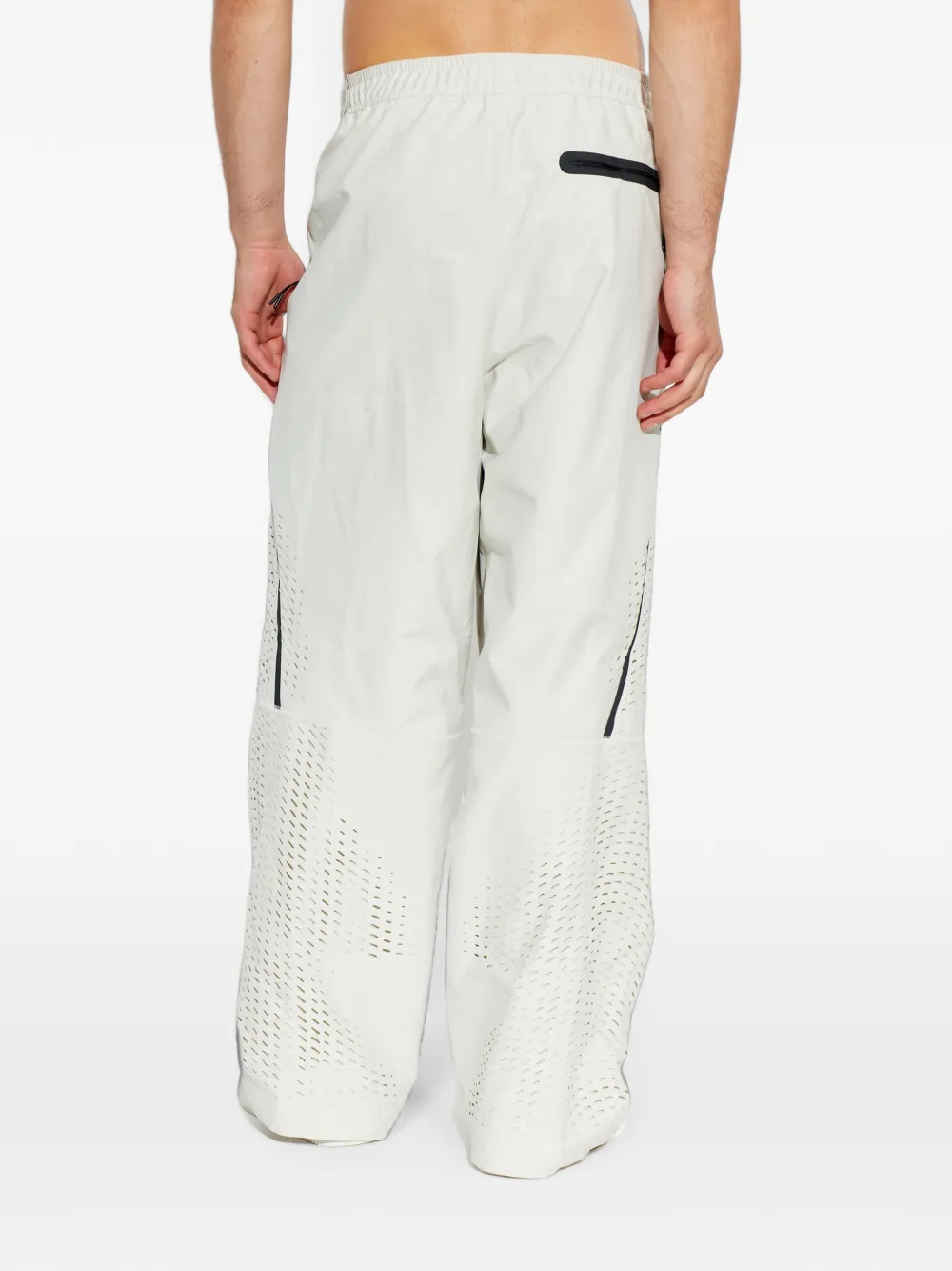 Nike Trainingsbroek met wijde pijpen en geperforeerde details Beige