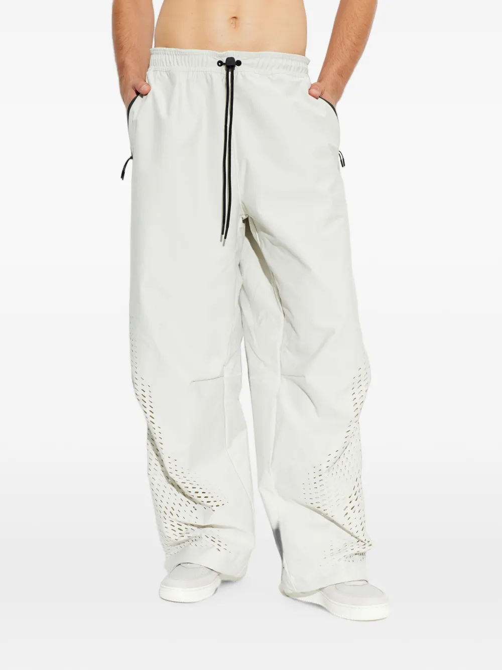 Nike Trainingsbroek met wijde pijpen en geperforeerde details Beige