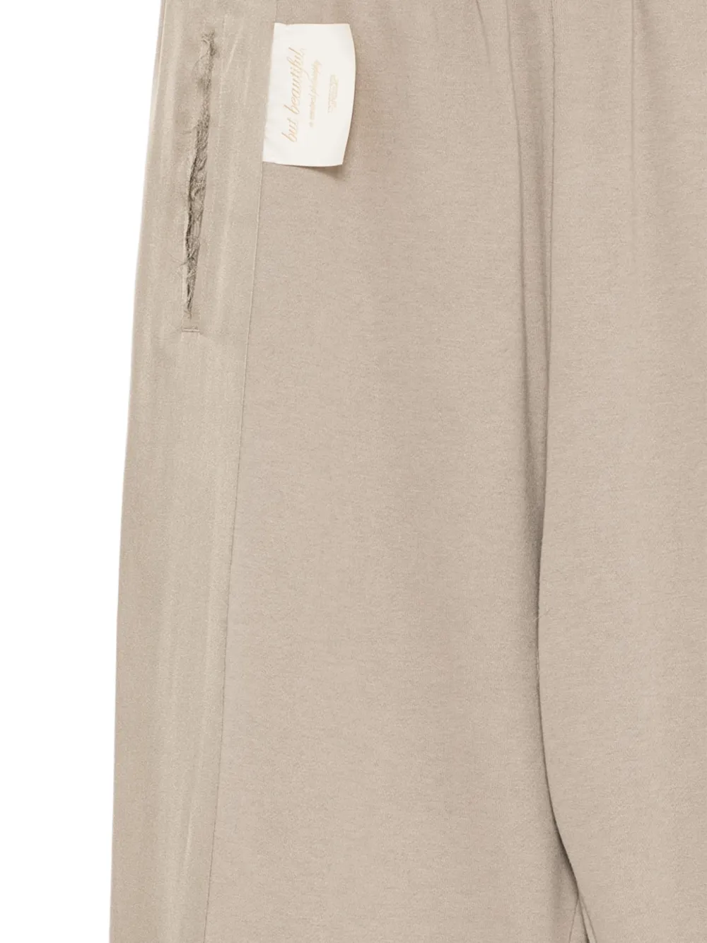 Undercover distressed-effect panelled track pants Beige