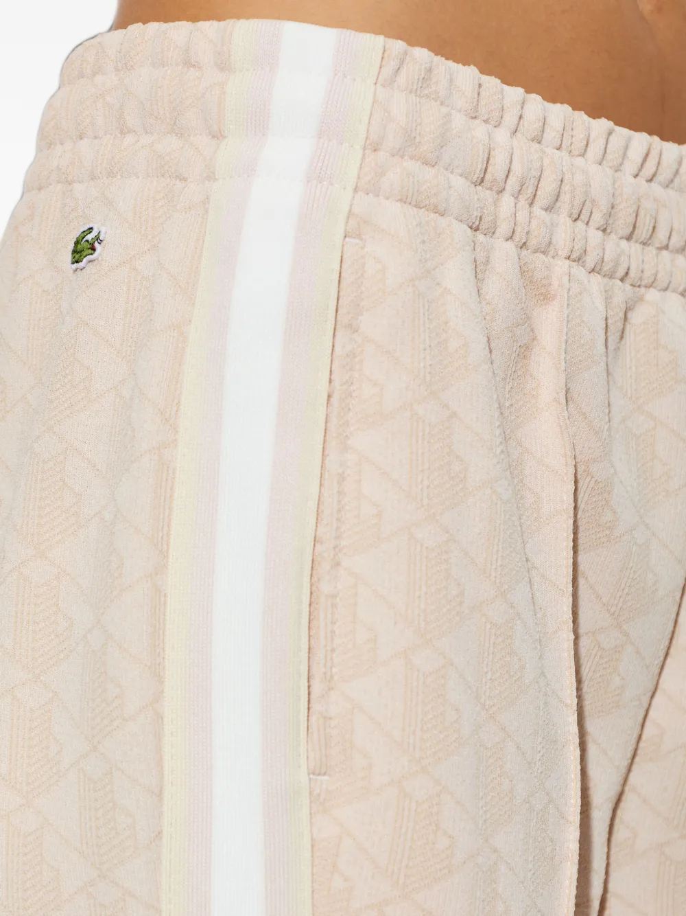 Lacoste Flared trainingsbroek met monogram-patroon Roze