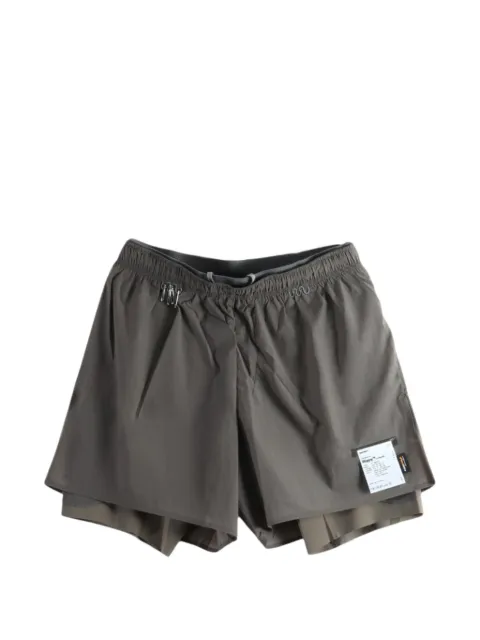 Satisfy layered logo-patch shorts