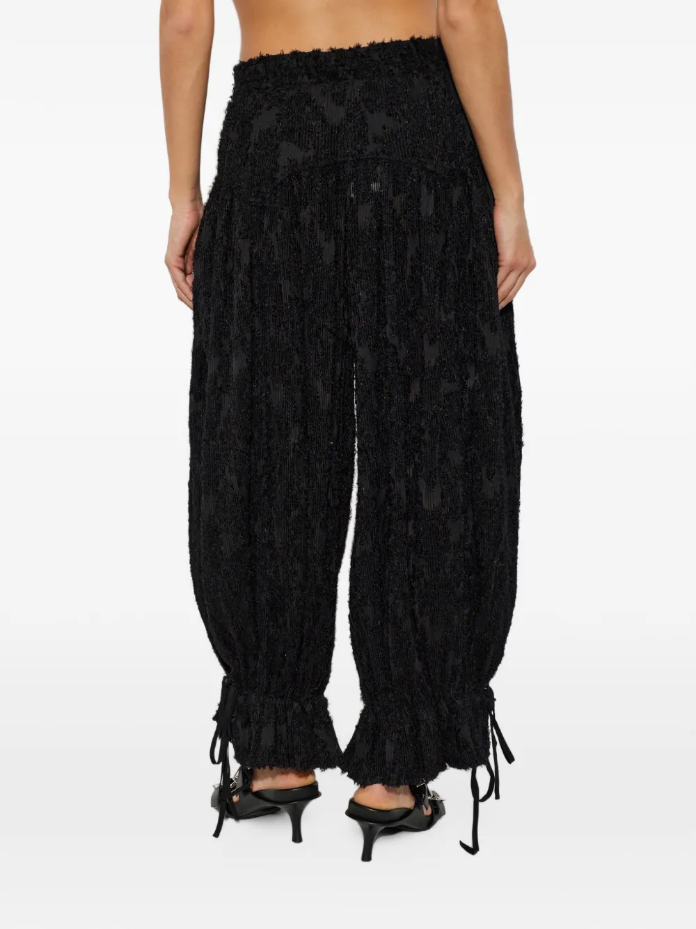 GANNI pleated frayed-effect trousers Zwart