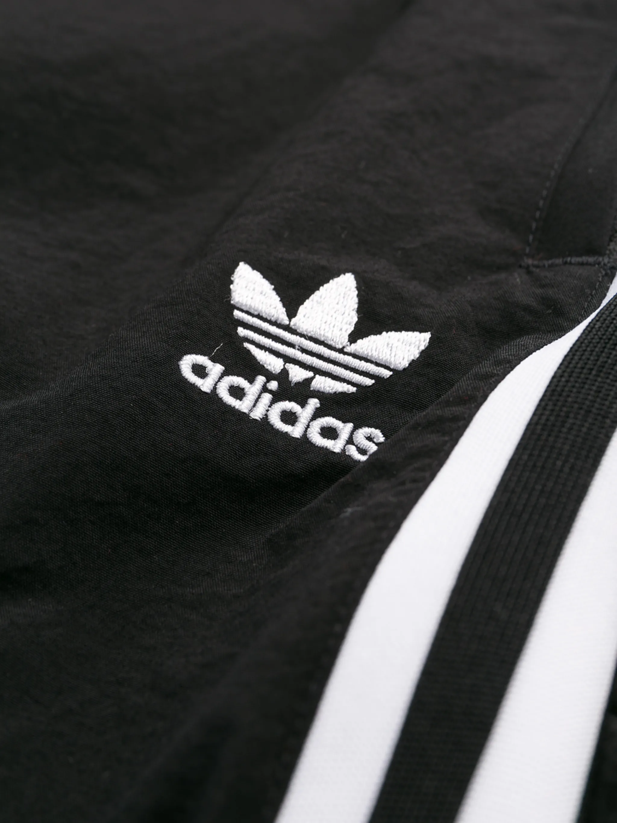 white and black adidas track pants