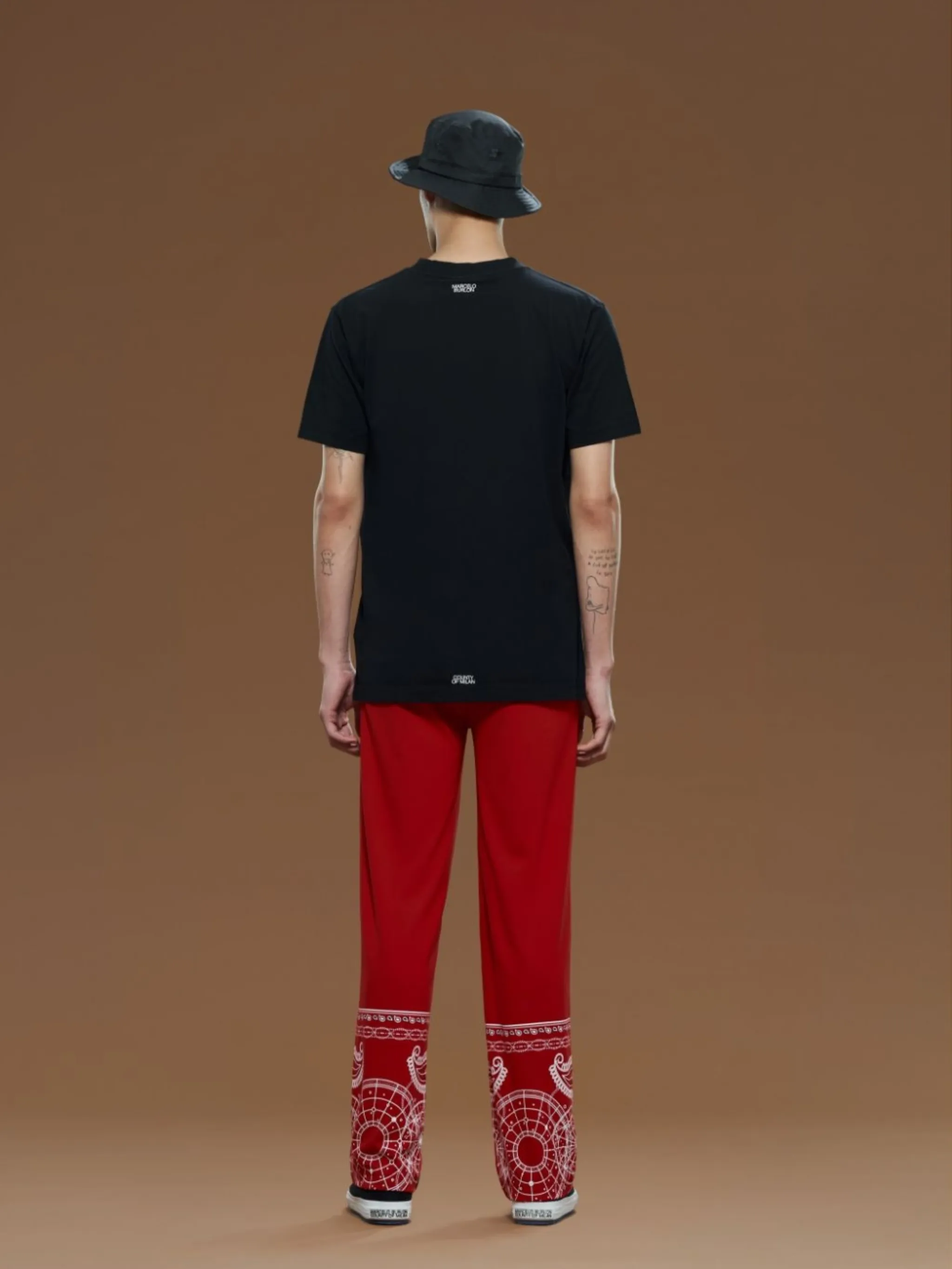bandana-print track pants from Marcelo Burlon County of Milan featuring bright red, white, bandana print, logo patch to the side, elasticated waistband, two diagonal pockets to the sides, rear jetted pocket, wide leg and extra-long length.