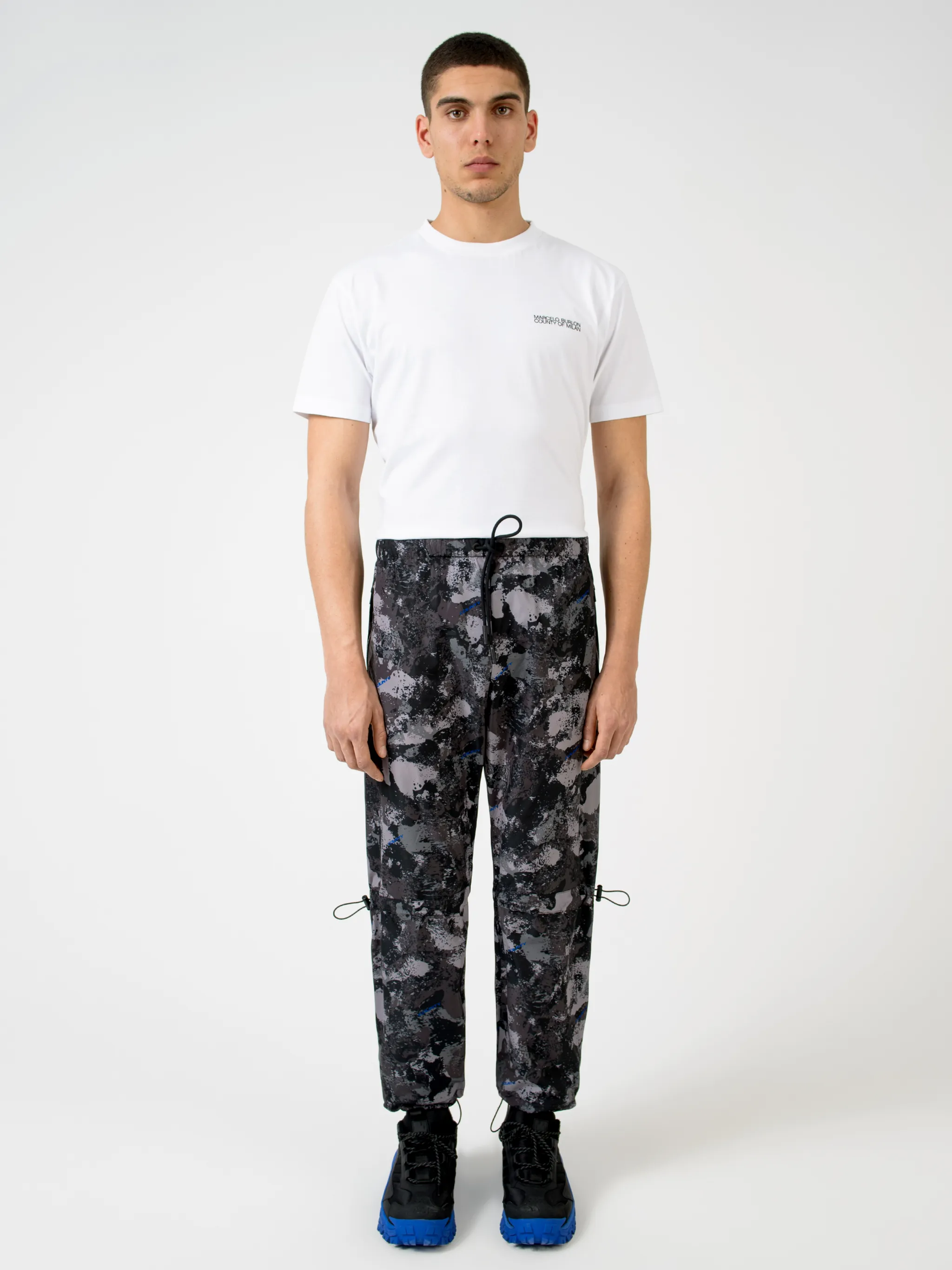 Dark grey high-rise camouflage-print track pants from MARCELO BURLON COUNTY OF MILAN featuring camouflage pattern, high waist, drawstring fastening waist, two side slit pockets, straight leg and ankle-length.