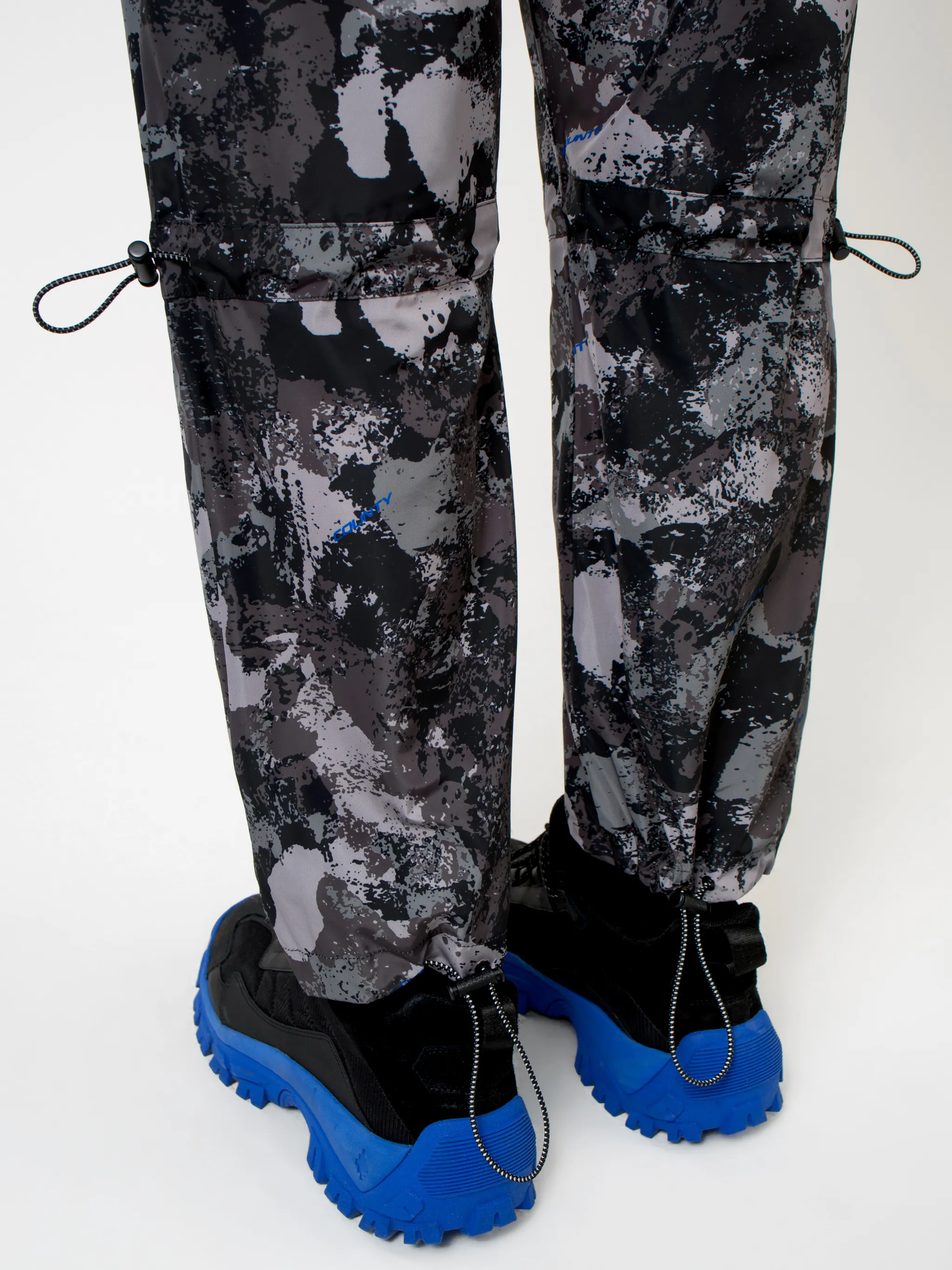 Dark grey high-rise camouflage-print track pants from MARCELO BURLON COUNTY OF MILAN featuring camouflage pattern, high waist, drawstring fastening waist, two side slit pockets, straight leg and ankle-length.