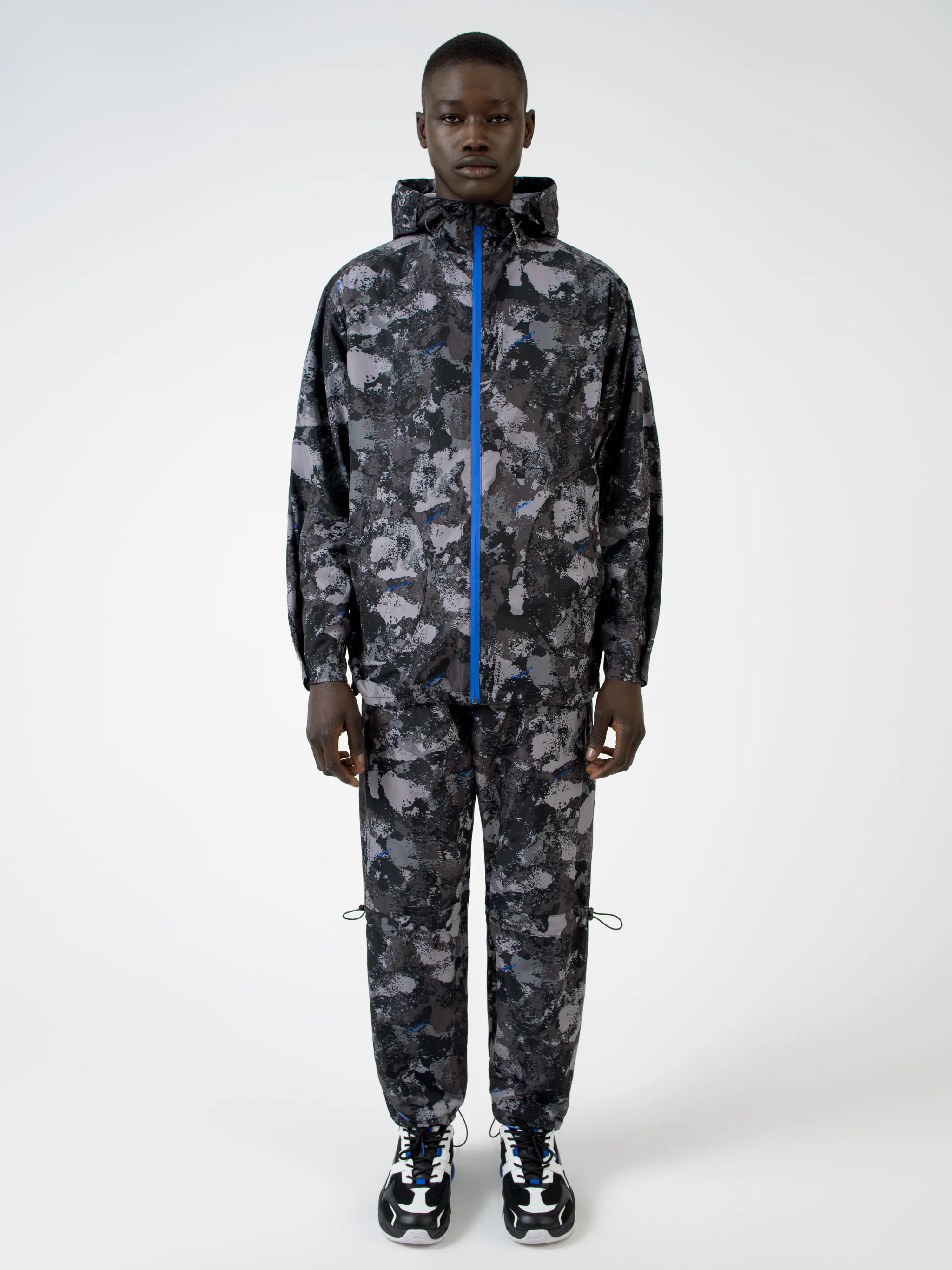 Tonal grey/royal blue camouflage print hooded windbreaker from Marcelo Burlon County of Milan featuring camouflage print, drawstring hood, front zip fastening, two side patch pockets, long sleeves and drawstring hem.