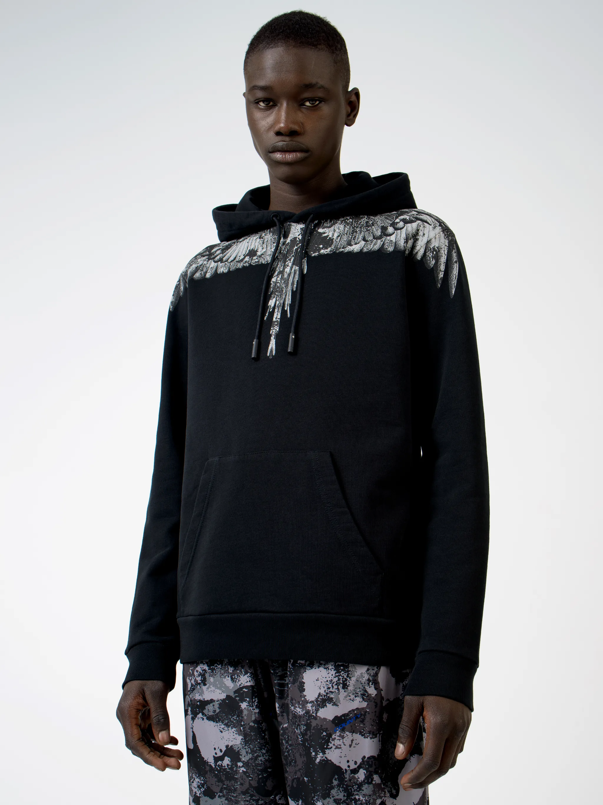 Black cotton wings-print hoodie from MARCELO BURLON COUNTY OF MILAN featuring drawstring hood, elasticated cuffs, elasticated hem and front pouch pocket.