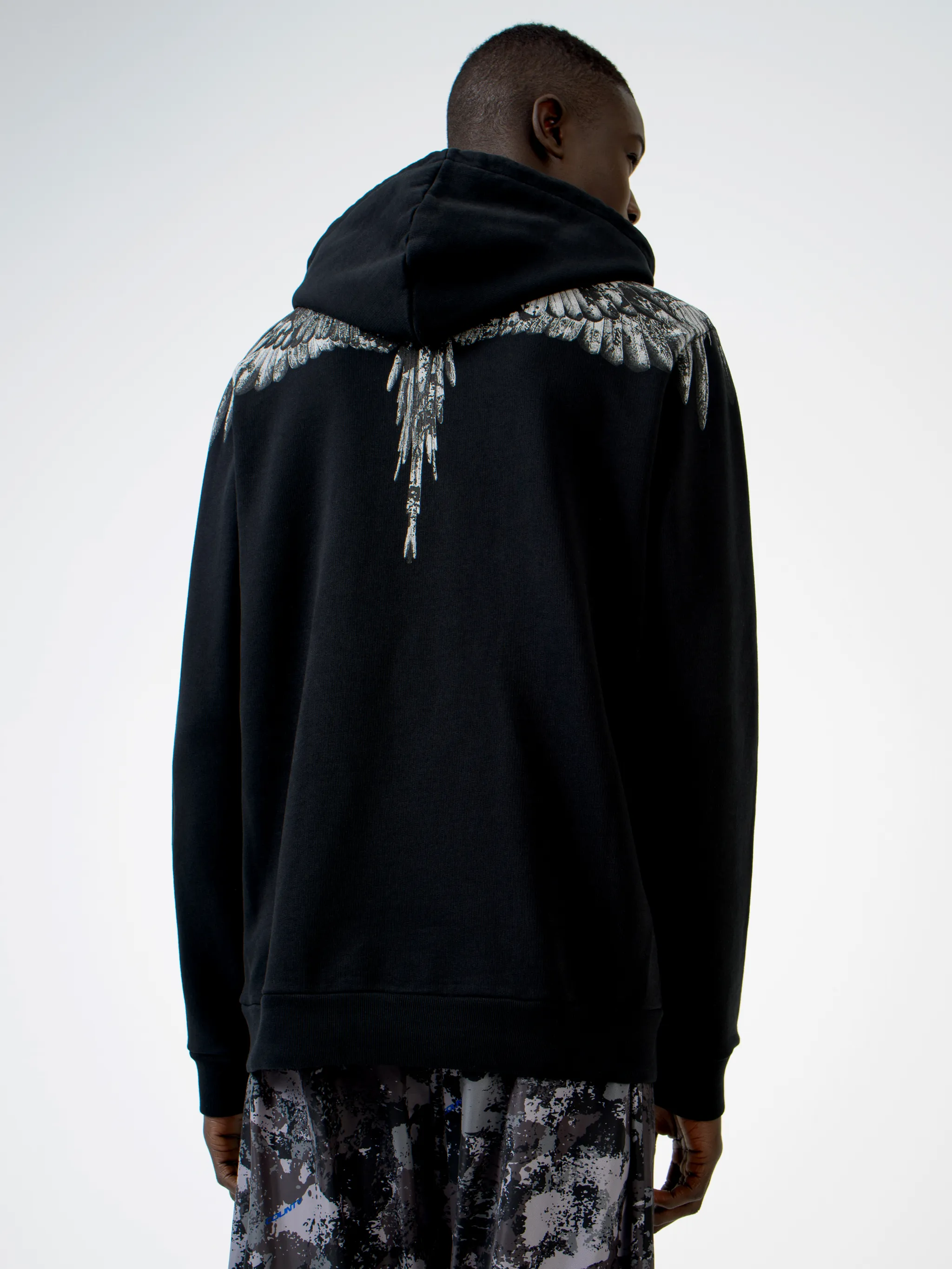 Black cotton wings-print hoodie from MARCELO BURLON COUNTY OF MILAN featuring drawstring hood, elasticated cuffs, elasticated hem and front pouch pocket.