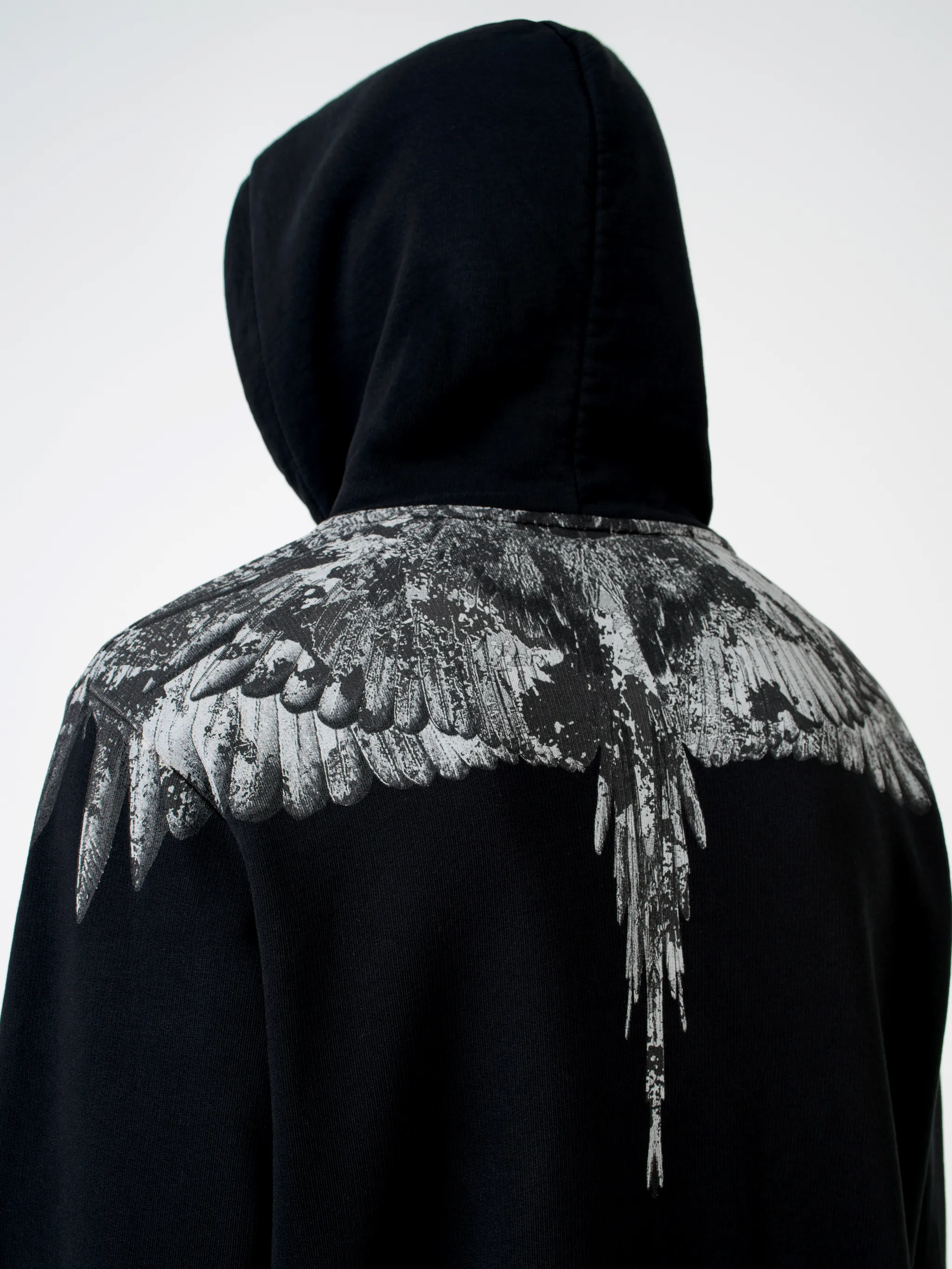 Black cotton wings-print hoodie from MARCELO BURLON COUNTY OF MILAN featuring drawstring hood, elasticated cuffs, elasticated hem and front pouch pocket.