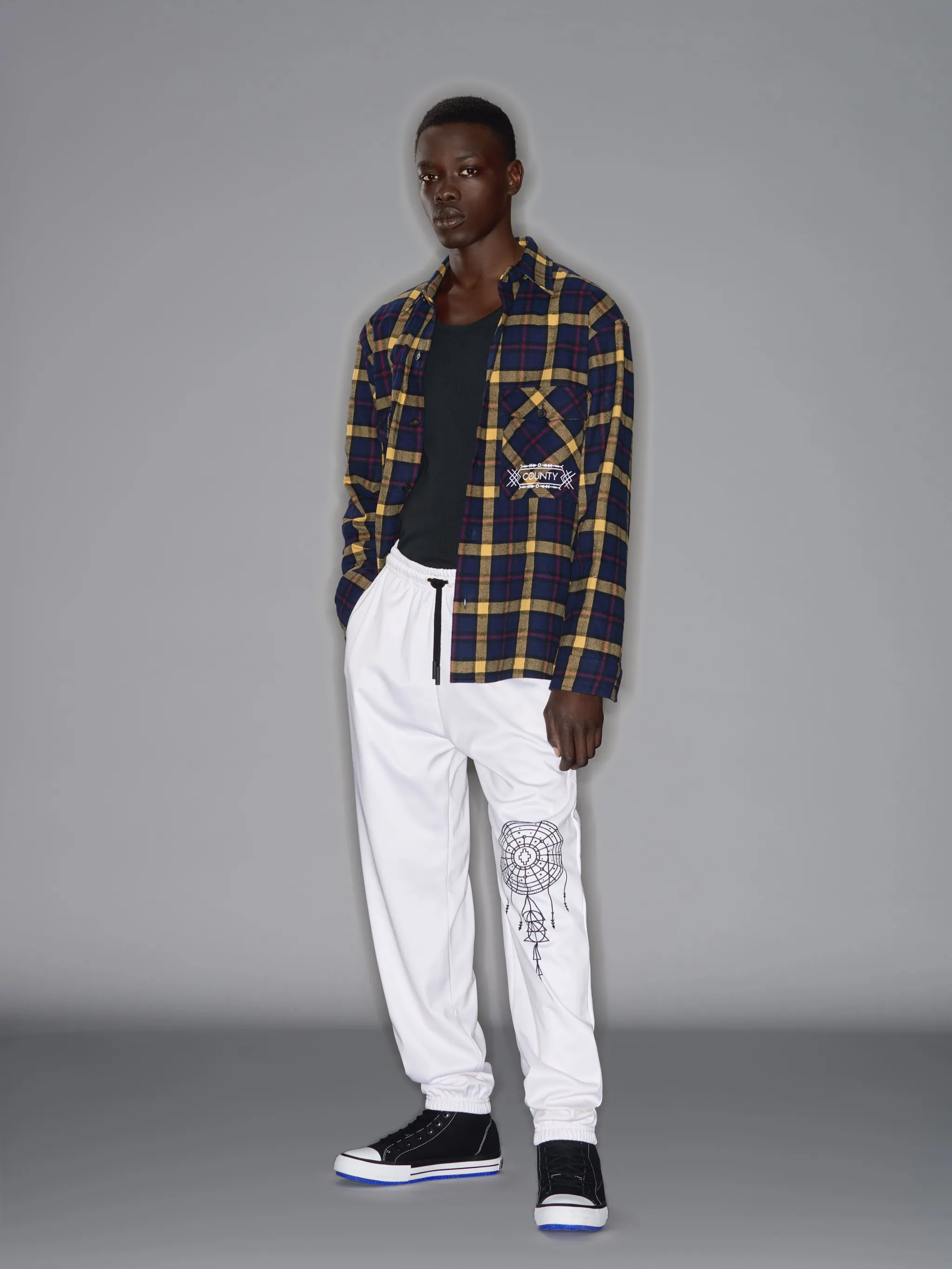 Blue/yellow recycled cotton blend folk check pattern shirt from Marcelo Burlon County of Milan featuring classic collar, front button fastening, two chest patch pockets, curved hem and buttoned-cuff sleeves.