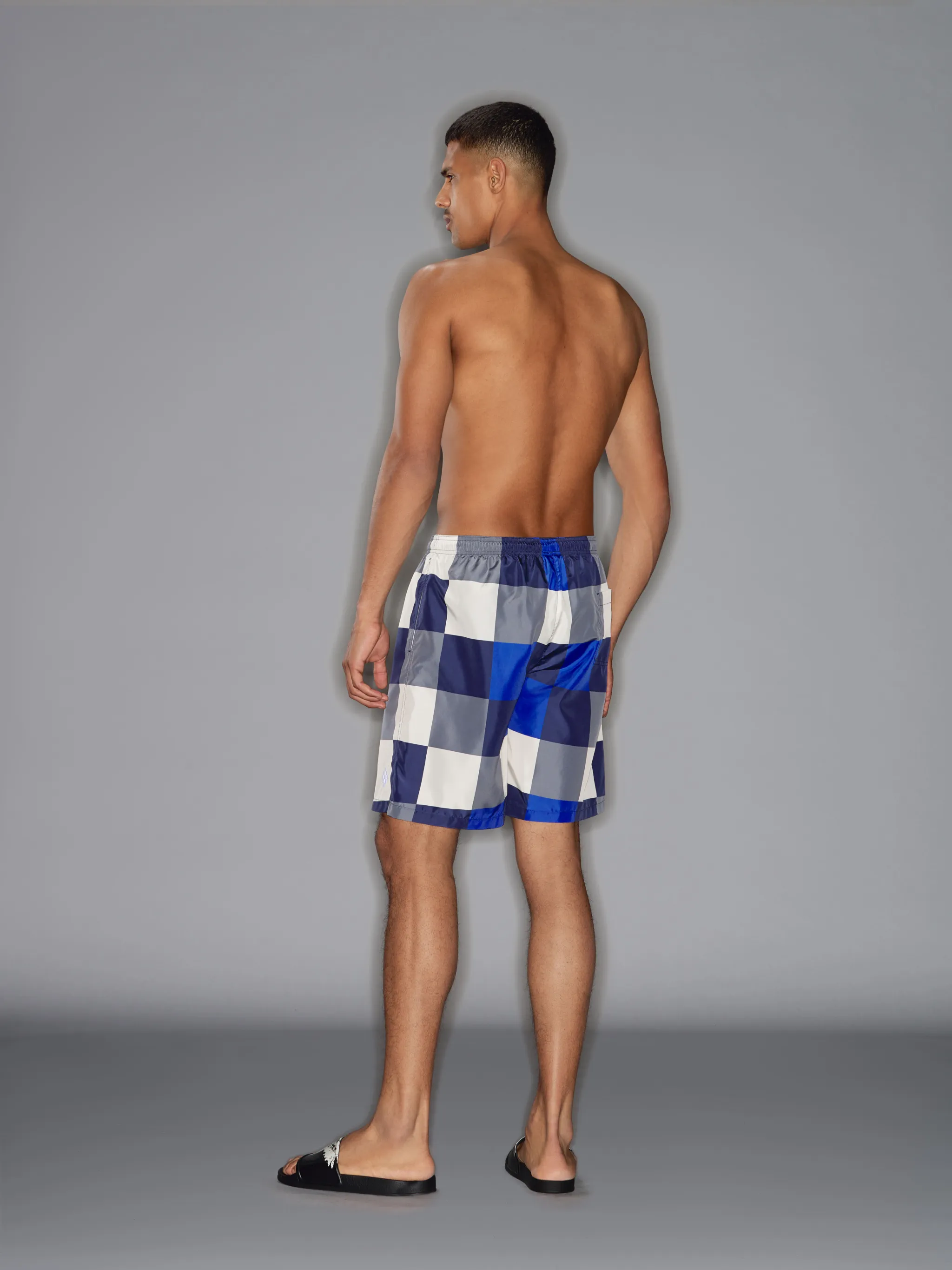 Multicolour checkerboard board shorts from Marcelo Burlon County of Milan featuring elasticated drawstring waistband, two side slit pockets, tonal stitching and rear pouch pocket. Be mindful to try on swimwear over your own garments..