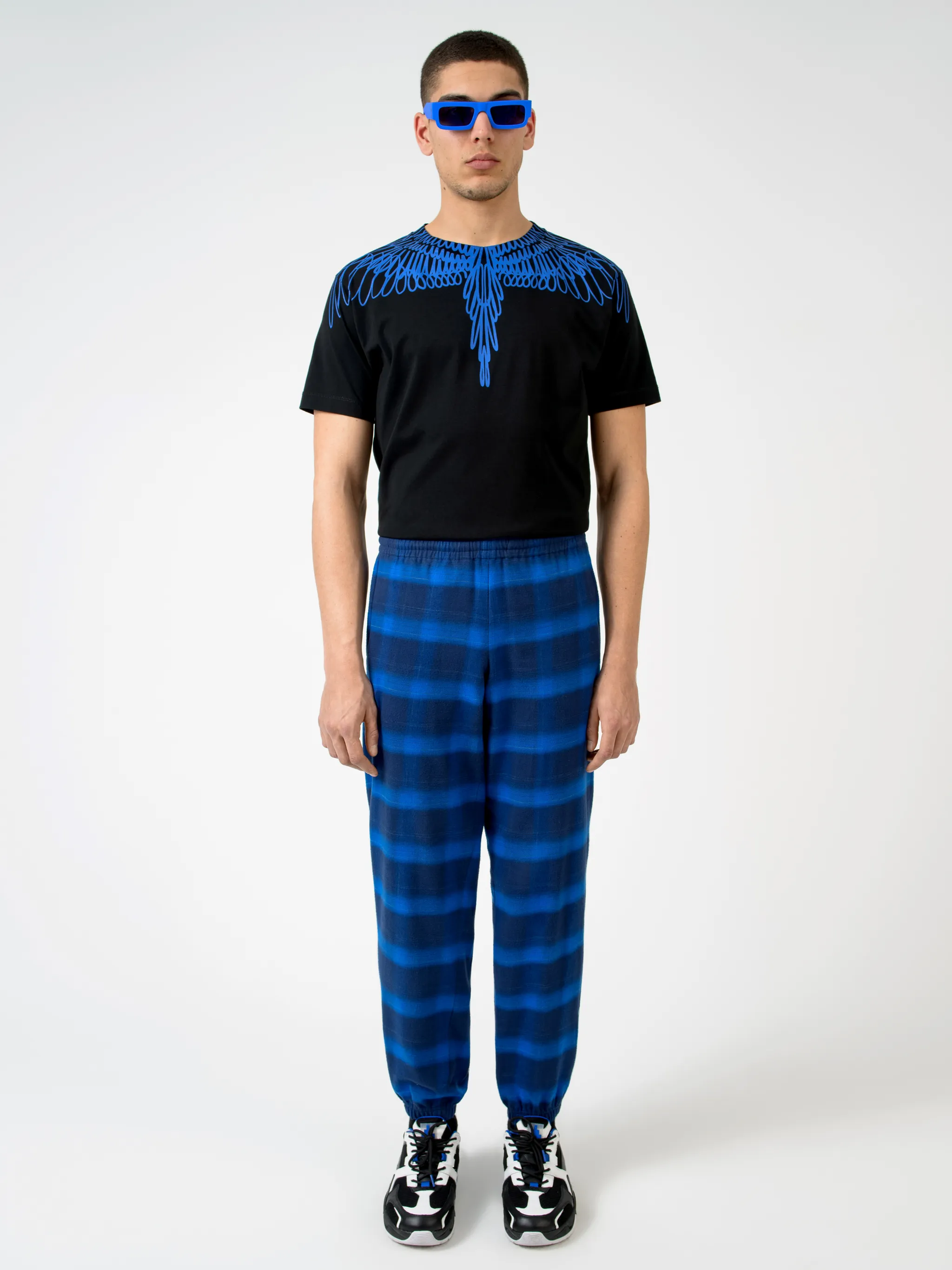 Blue/black cotton check-pattern tapered track pants from Marcelo Burlon County of Milan featuring check pattern, elasticated ankles, elasticated waistband, tapered design and two side slit pockets.