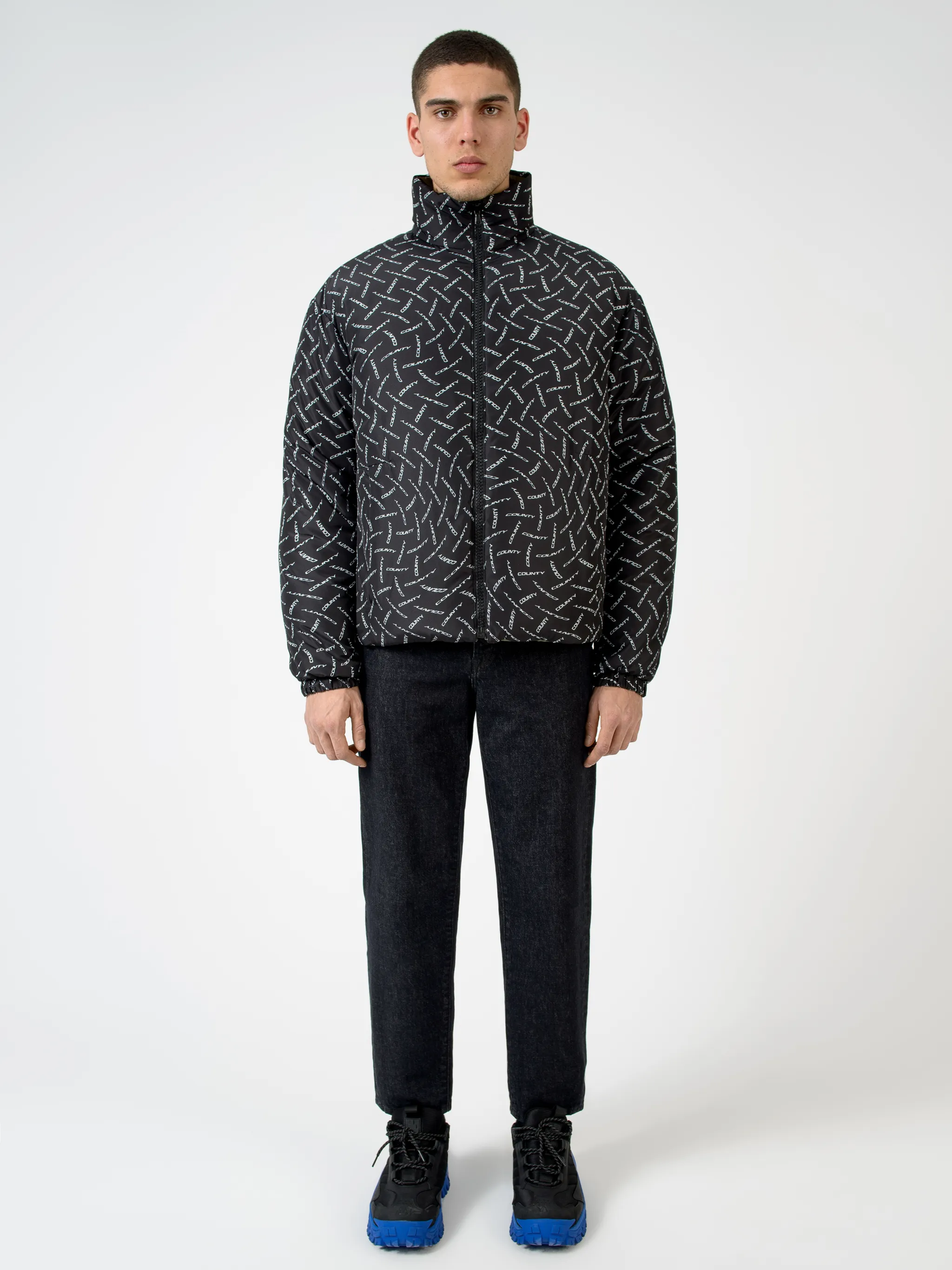 Black/white County logo print padded jacket from Marcelo Burlon County of Milan featuring all-over logo print, padded design, high neck, front zip fastening, two side patch pockets, long sleeves and straight hem.
