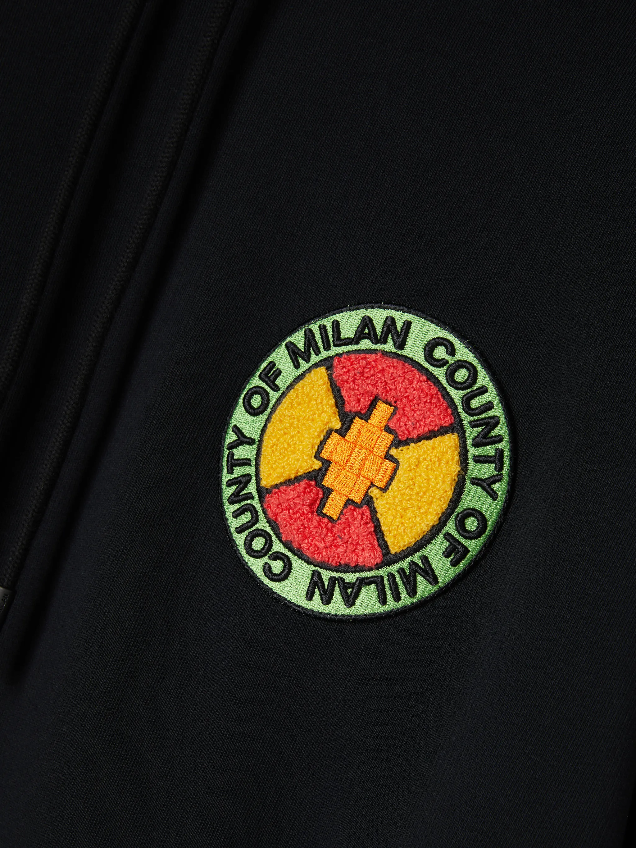 Black/multicolour organic cotton County Park-patch hoodie from Marcelo Burlon County of Milan featuring logo patch to the front, drawstring hood, drop shoulder, long sleeves and front pouch pocket. POSITIVELY CONSCIOUS: This Planet Conscious product is made from at least 50% organic materials, which helps you support organic farming practices such as the restricted use of synthetic chemicals and genetically modified seeds, improved soil fertility and better livestock management..
