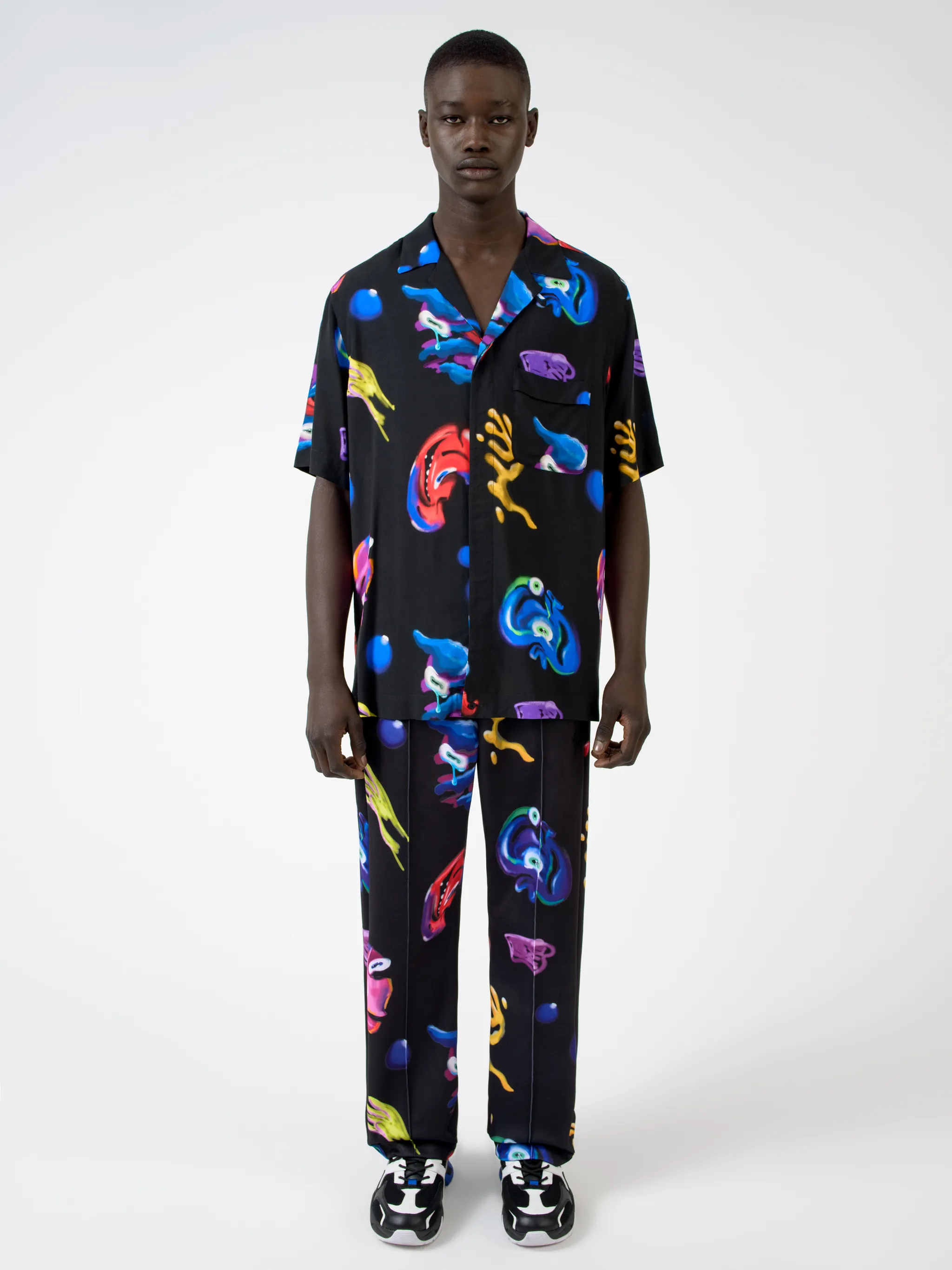 Black/multicolour Crazy Faces print shirt from Marcelo Burlon County of Milan featuring all-over logo print, spread collar, concealed front fastening, short sleeves and straight hem.