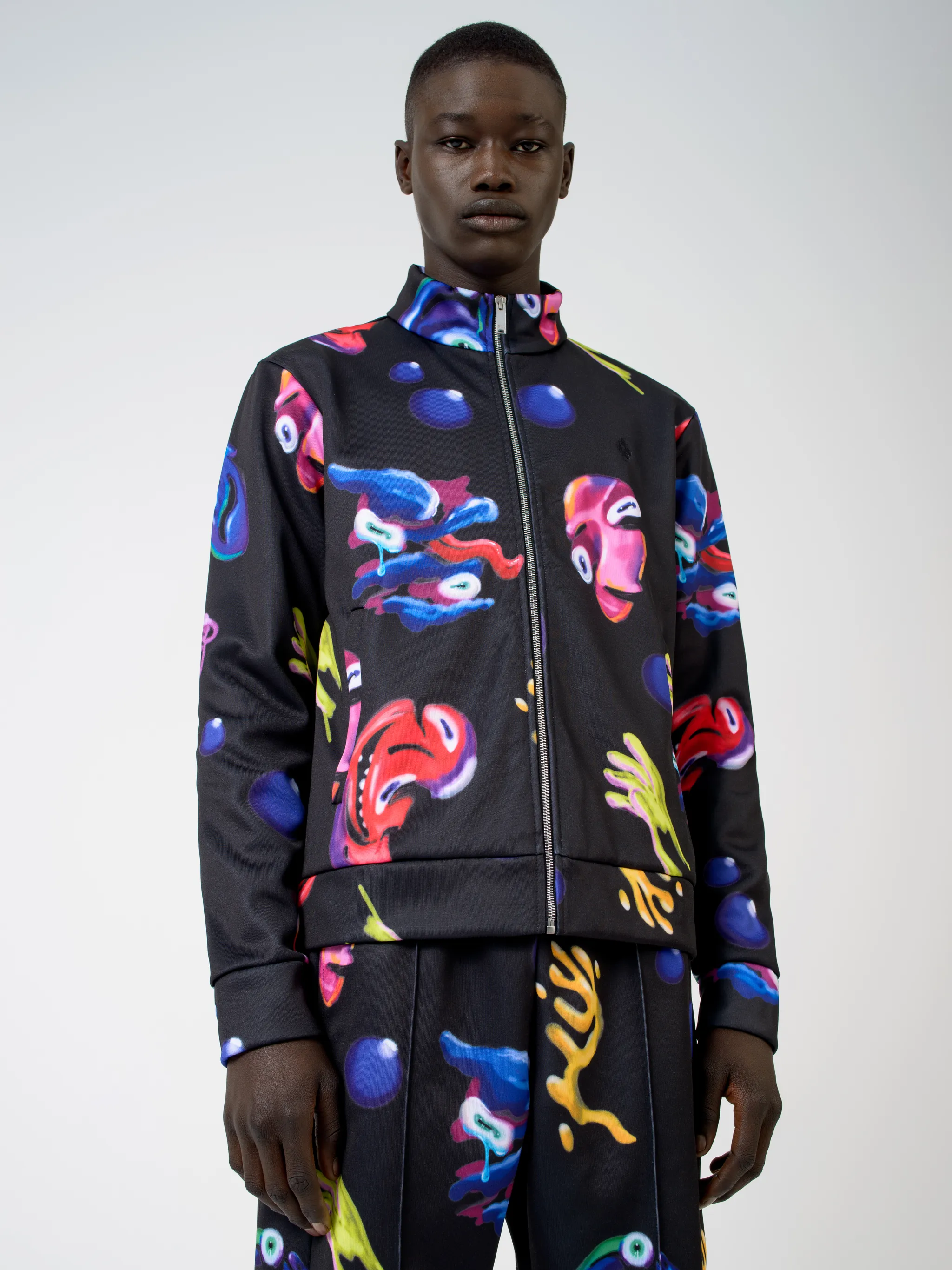 Black/multicolour cotton-blend Crazy Faces print jacket from Marcelo Burlon County of Milan featuring graphic print, stand-up collar, front zip fastening, two side patch pockets, long sleeves and straight hem.