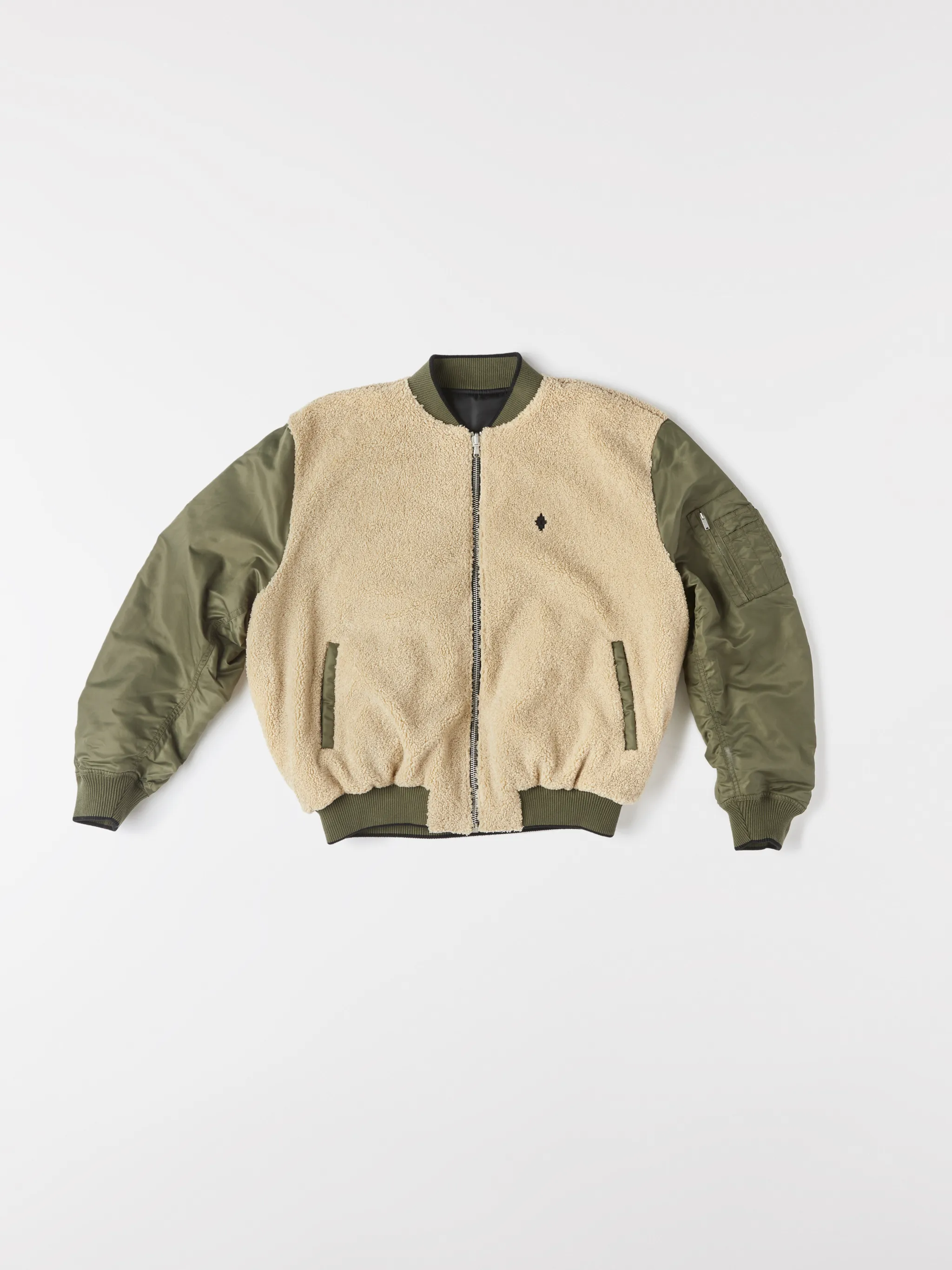 Army green/beige/black reversible panelled bomber jacket from Marcelo Burlon County of Milan featuring reversible, panelled design, embroidered logo to the rear, embroidered logo at the chest, ruched detailing, long sleeves, front zip fastening, two side slit pockets and ribbed edge.