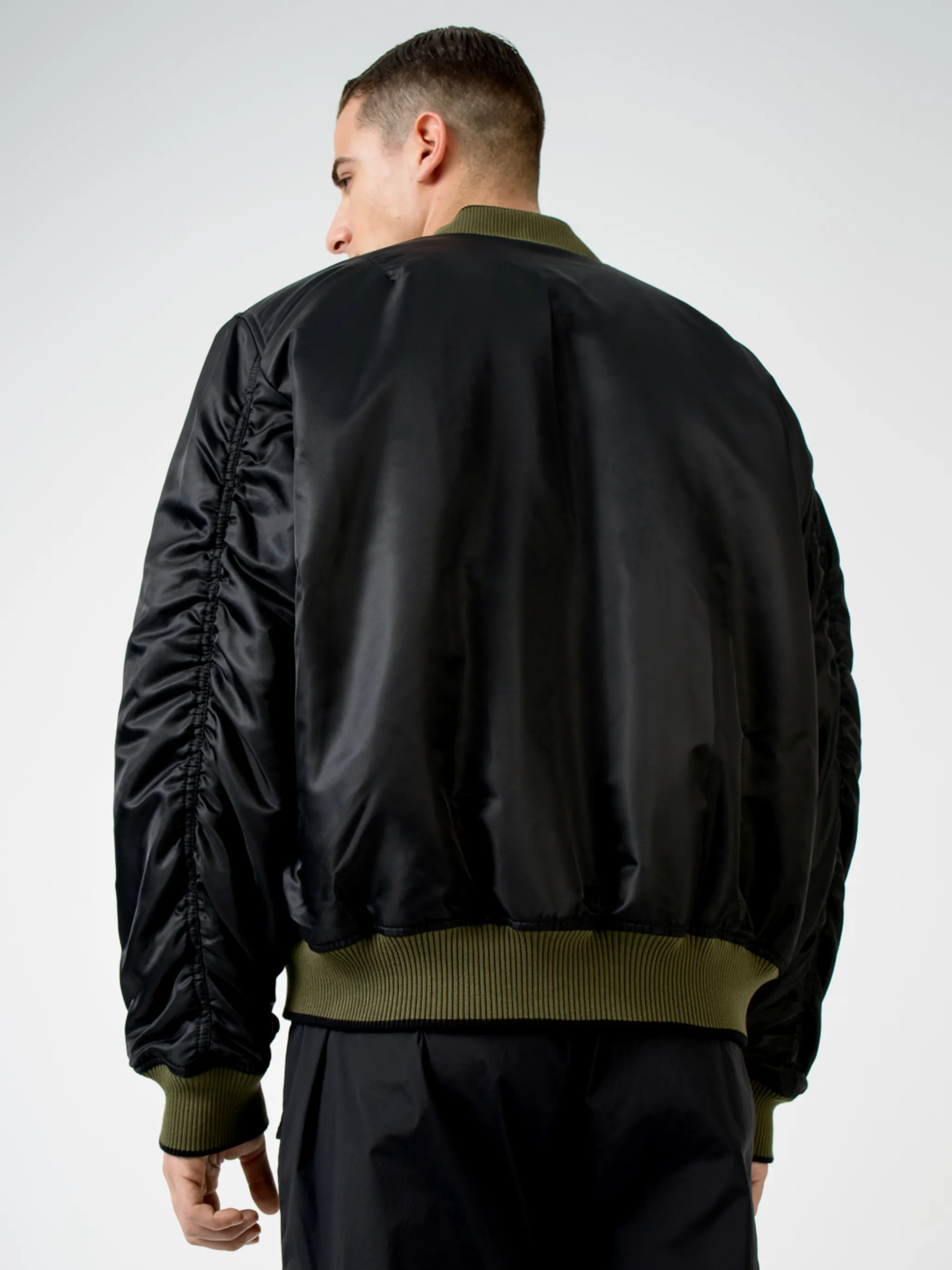 Army green/beige/black reversible panelled bomber jacket from Marcelo Burlon County of Milan featuring reversible, panelled design, embroidered logo to the rear, embroidered logo at the chest, ruched detailing, long sleeves, front zip fastening, two side slit pockets and ribbed edge.