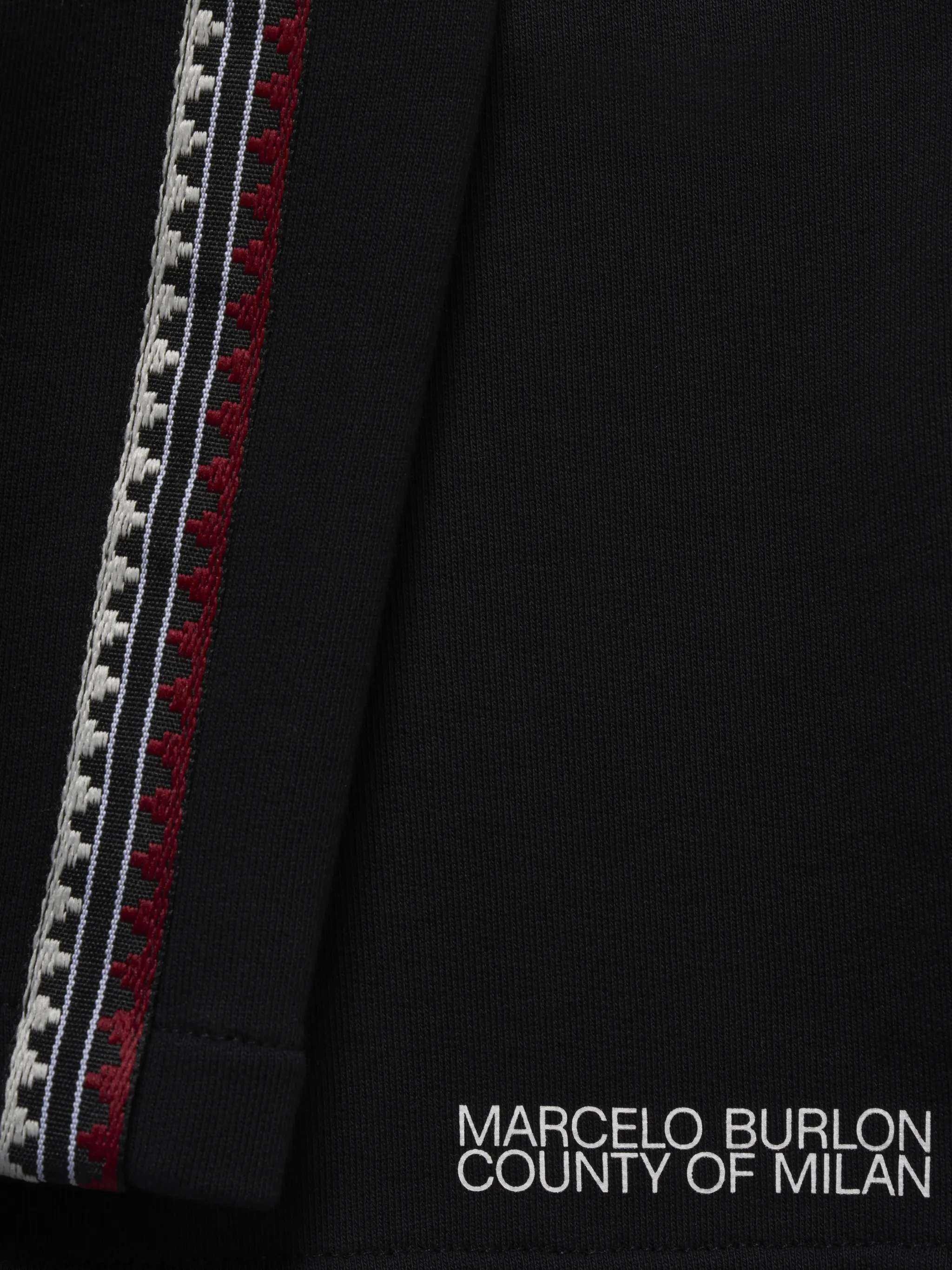 Black/red/white cotton tape-detail track shorts from Marcelo Burlon County of Milan featuring jersey fleece, tape detailing, logo print at the leg, elasticated drawstring waistband, two side slit pockets and rear welt pocket.