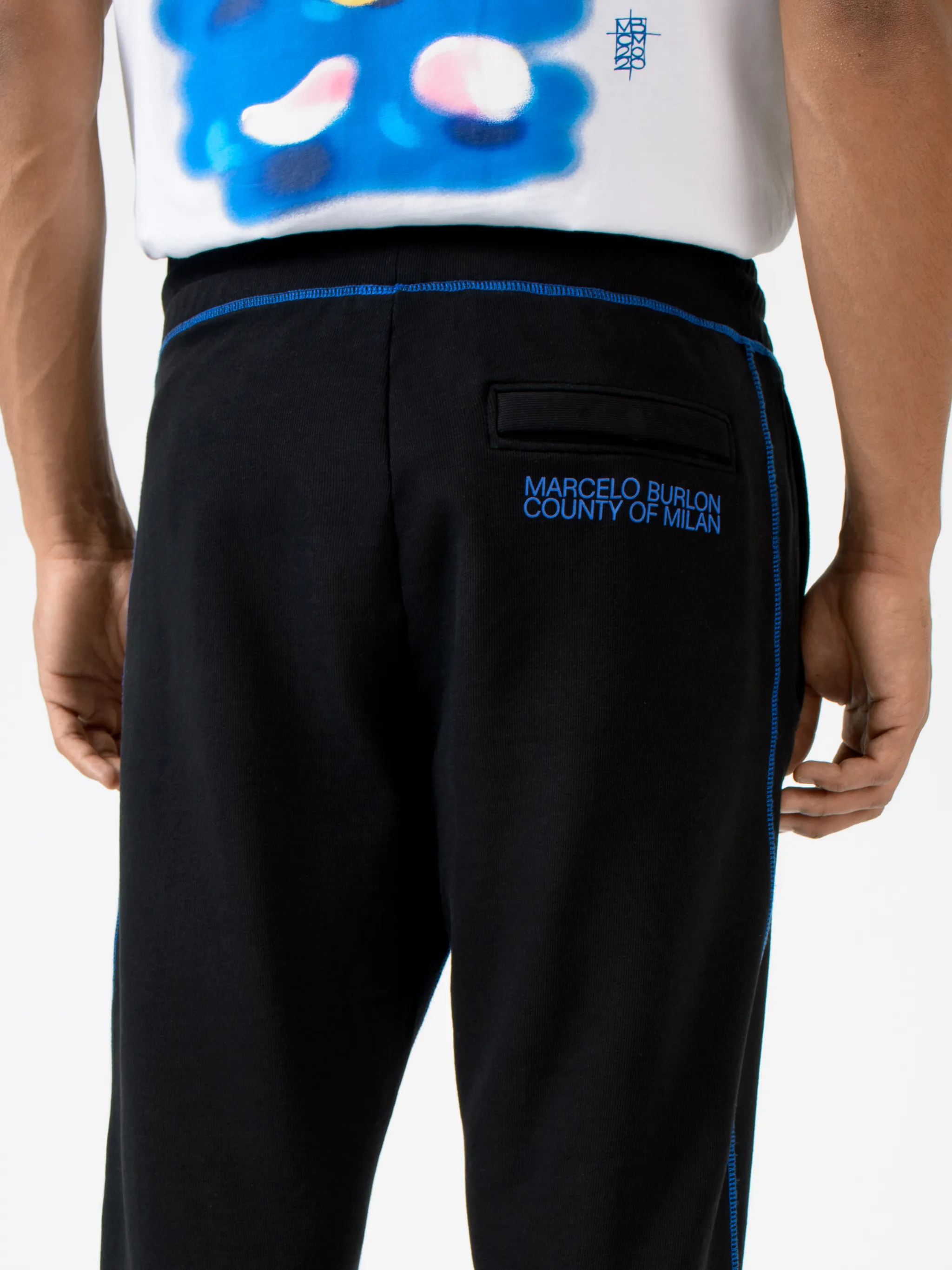 Black cotton Cross contrasting-trim track pants from Marcelo Burlon County of Milan featuring embroidered logo to the front, embroidered logo to the rear, contrasting trim, elasticated ankles, elasticated waistband, tapered design, two side slit pockets and rear welt pocket.