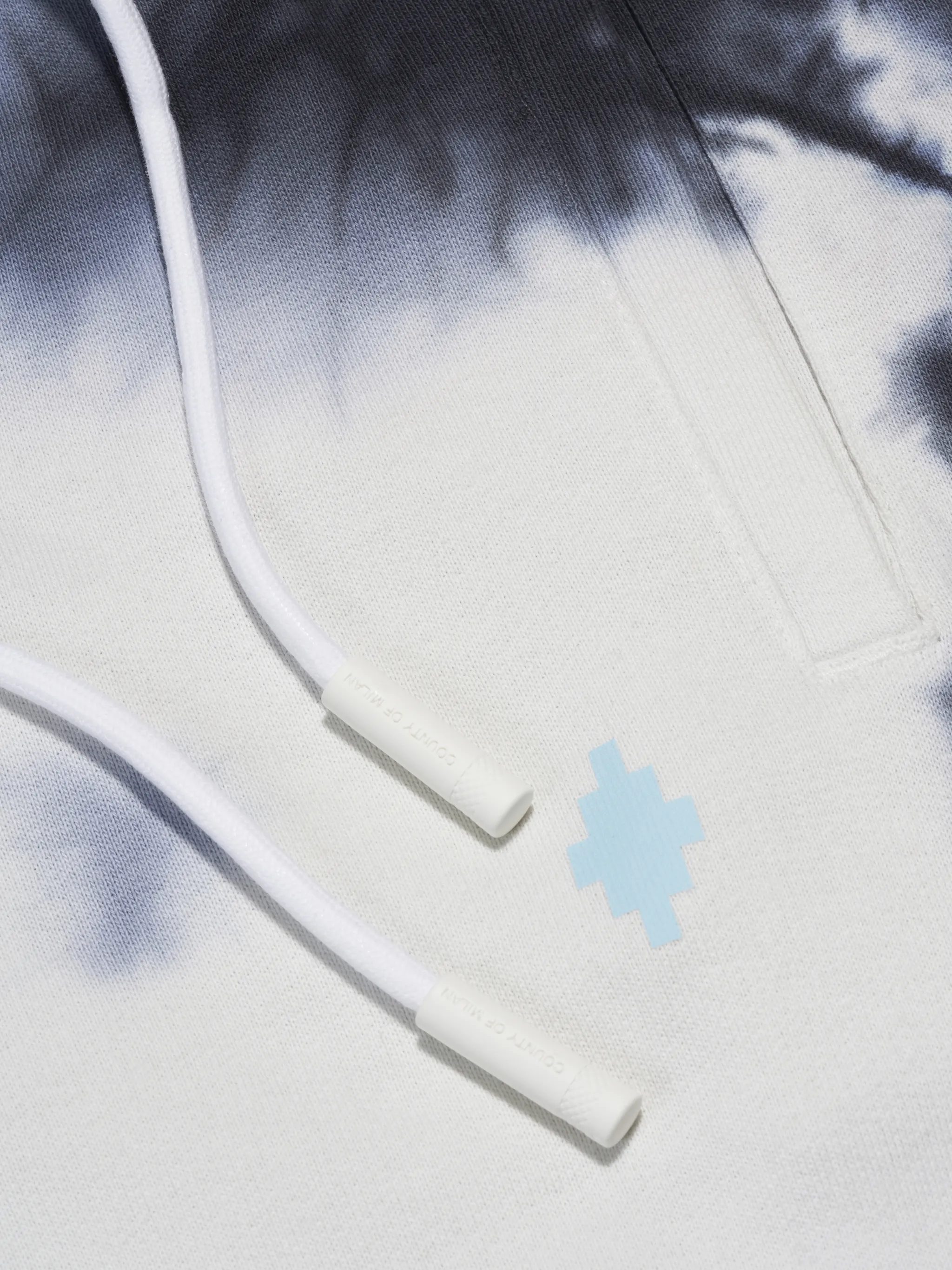 Dark blue/white cotton tie-dye print track pants from Marcelo Burlon County of Milan featuring elasticated waistband, drawstring fastening, tie-dye print, elasticated ankles, two side slit pockets and rear welt pocket.