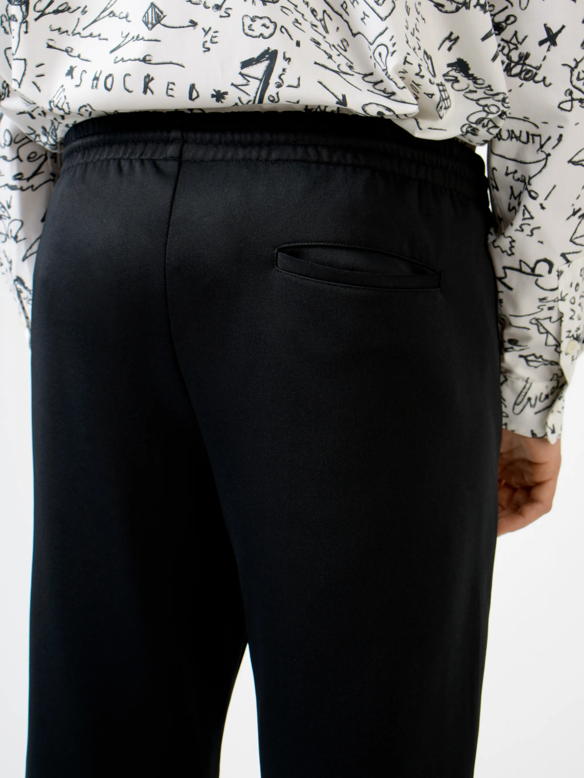 Black cotton-blend logo track pants from MARCELO BURLON COUNTY OF MILAN featuring elasticated waistband, embroidered logo, two side slit pockets, rear welt pocket, side stripe detailing and loose fit.