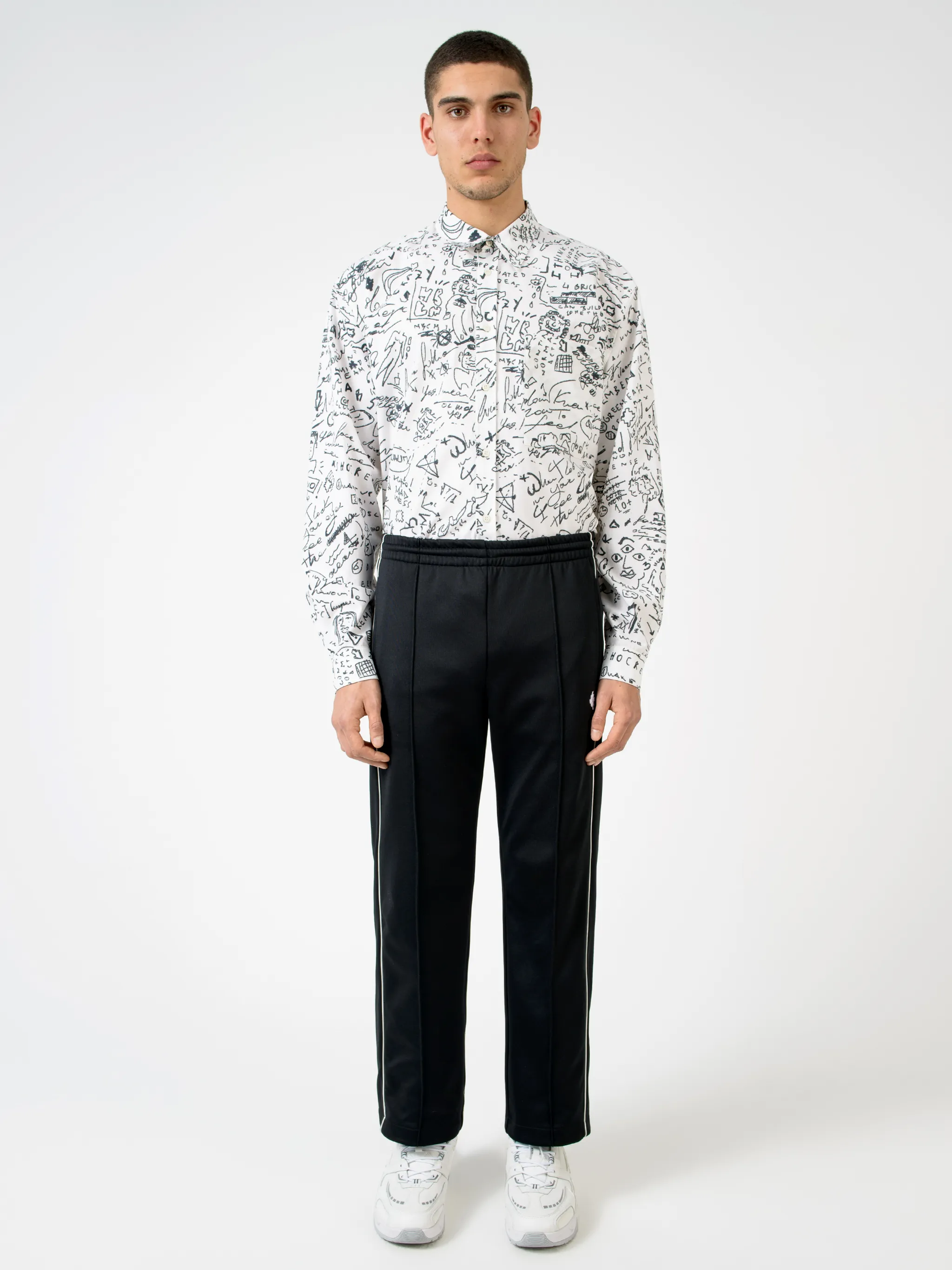 Black cotton-blend logo track pants from MARCELO BURLON COUNTY OF MILAN featuring elasticated waistband, embroidered logo, two side slit pockets, rear welt pocket, side stripe detailing and loose fit.