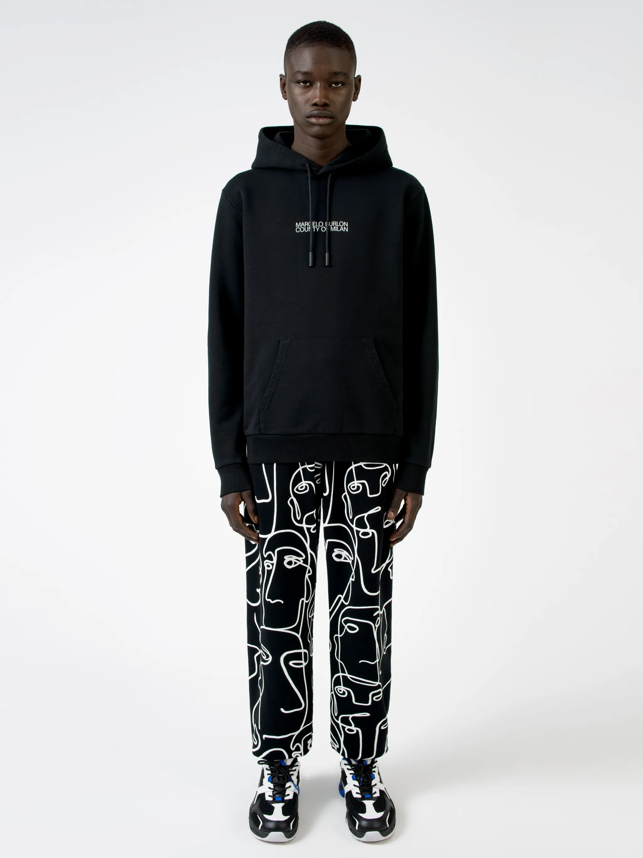 Black cotton logo print hoodie from MARCELO BURLON COUNTY OF MILAN featuring drawstring hood, logo print to the front, long sleeves, abstract pattern print, kangaroo pocket and loose fit.