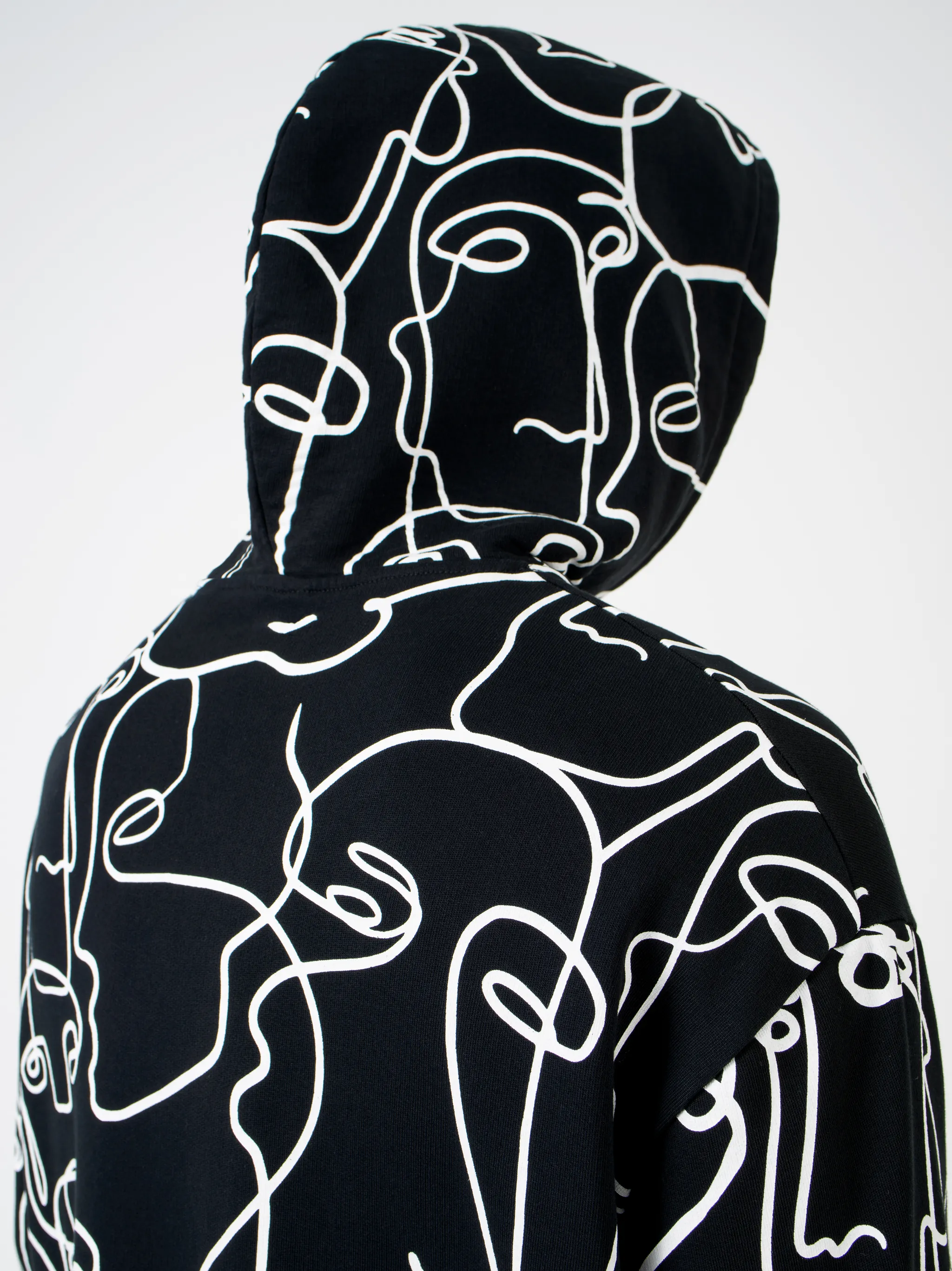 Black/white cotton all-over Faces print hoodie from Marcelo Burlon County of Milan featuring all-over logo print, drawstring hood, two front pouch pockets, long sleeves and straight hem.