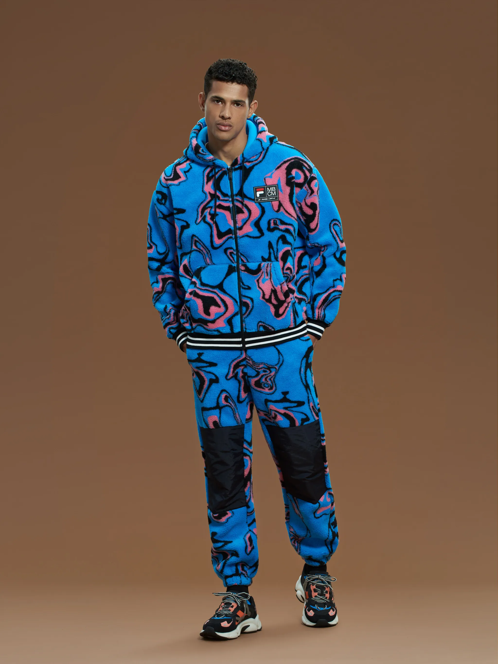 Blue/pink/black x FILA Psych print hooded jacket from Marcelo Burlon County of Milan featuring wave print, logo patch at the chest, stripe trim, drawstring hood, drop shoulder, long sleeves, front zip fastening and two front pouch pockets.
