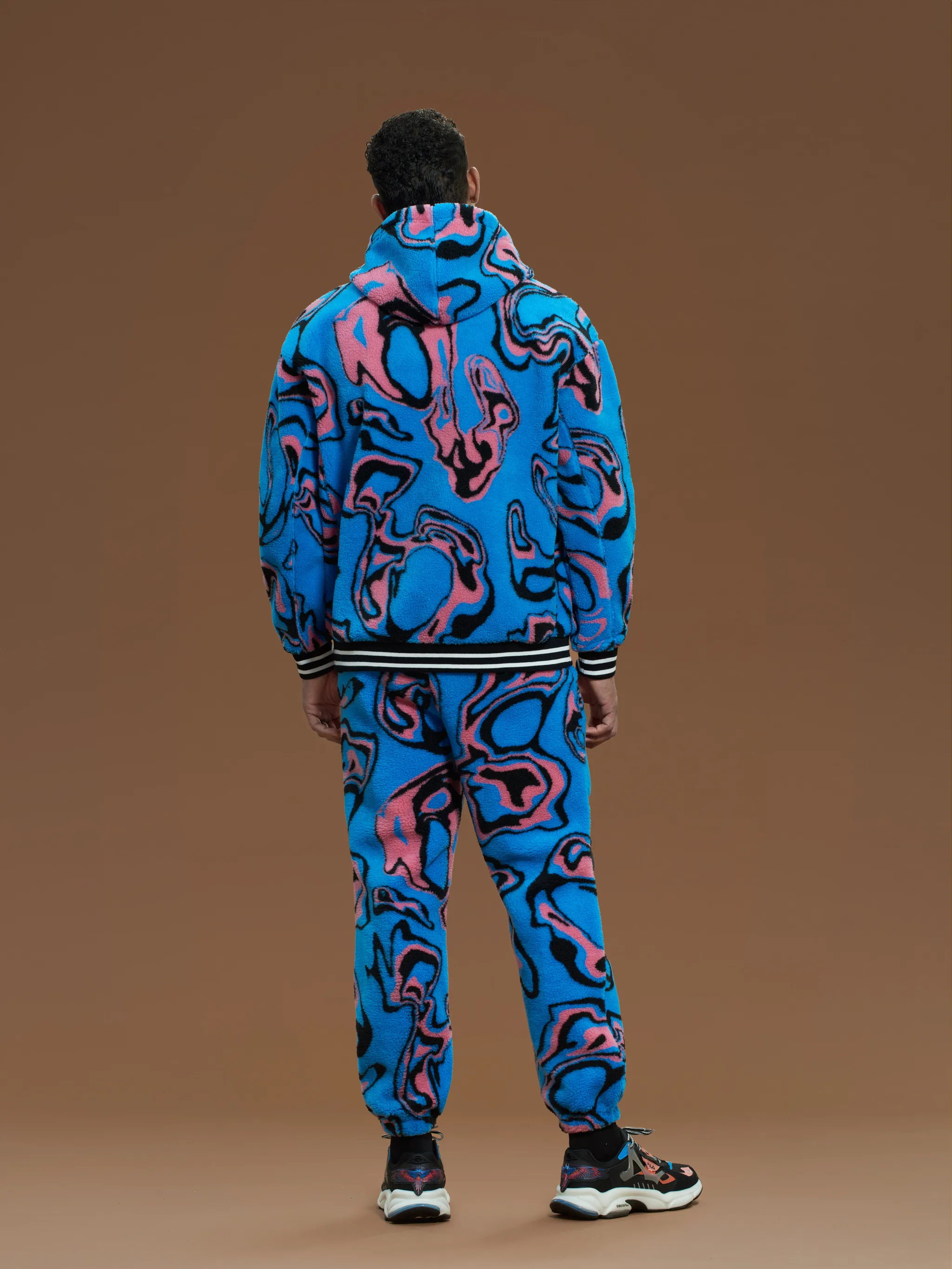 Blue/pink/black x FILA Psych print hooded jacket from Marcelo Burlon County of Milan featuring wave print, logo patch at the chest, stripe trim, drawstring hood, drop shoulder, long sleeves, front zip fastening and two front pouch pockets.