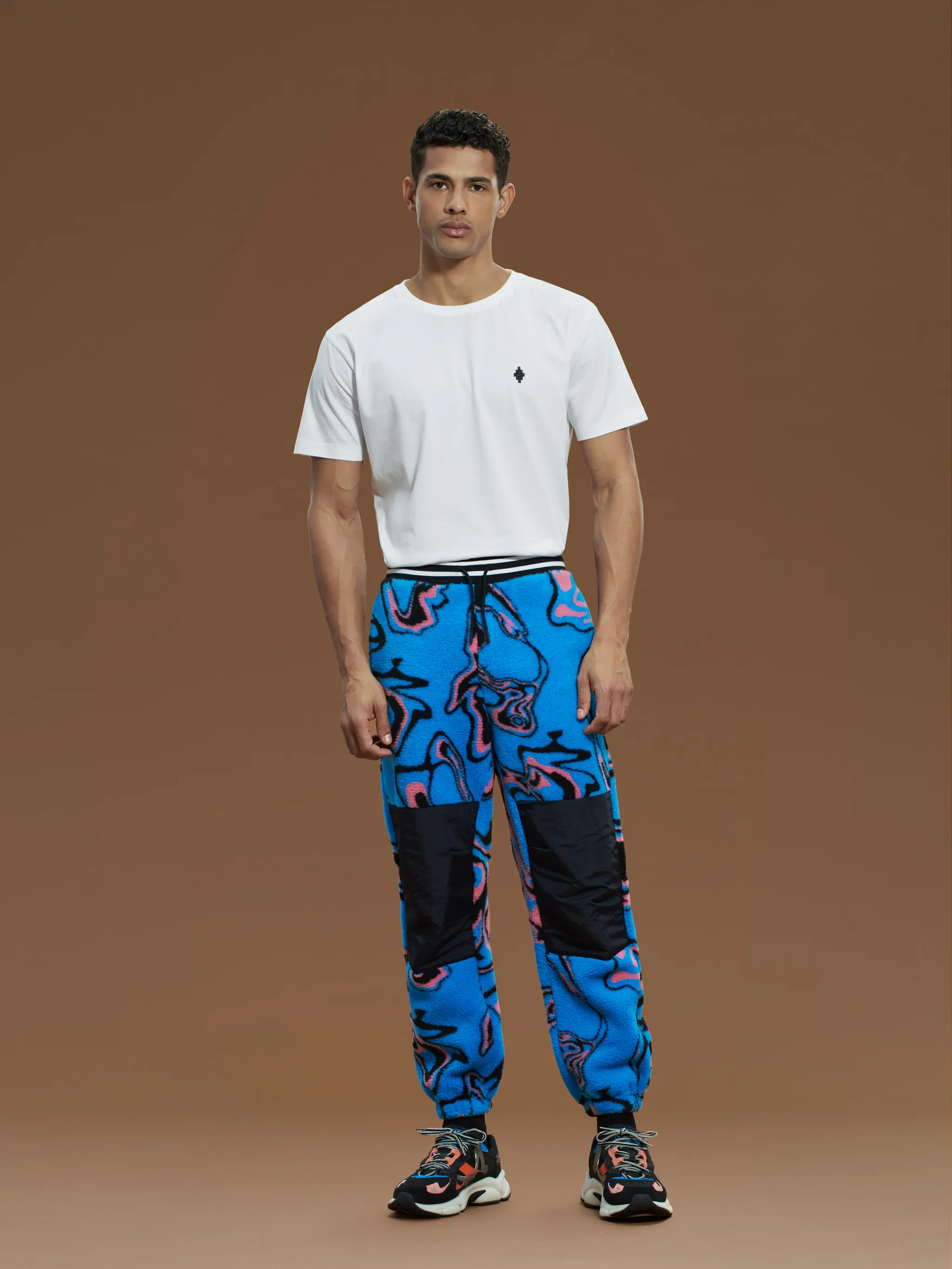 Multicolour geometric print trousers from Marcelo Burlon County of Milan featuring geometric-pattern print, wide leg, elasticated drawstring waistband and elasticated ankles.